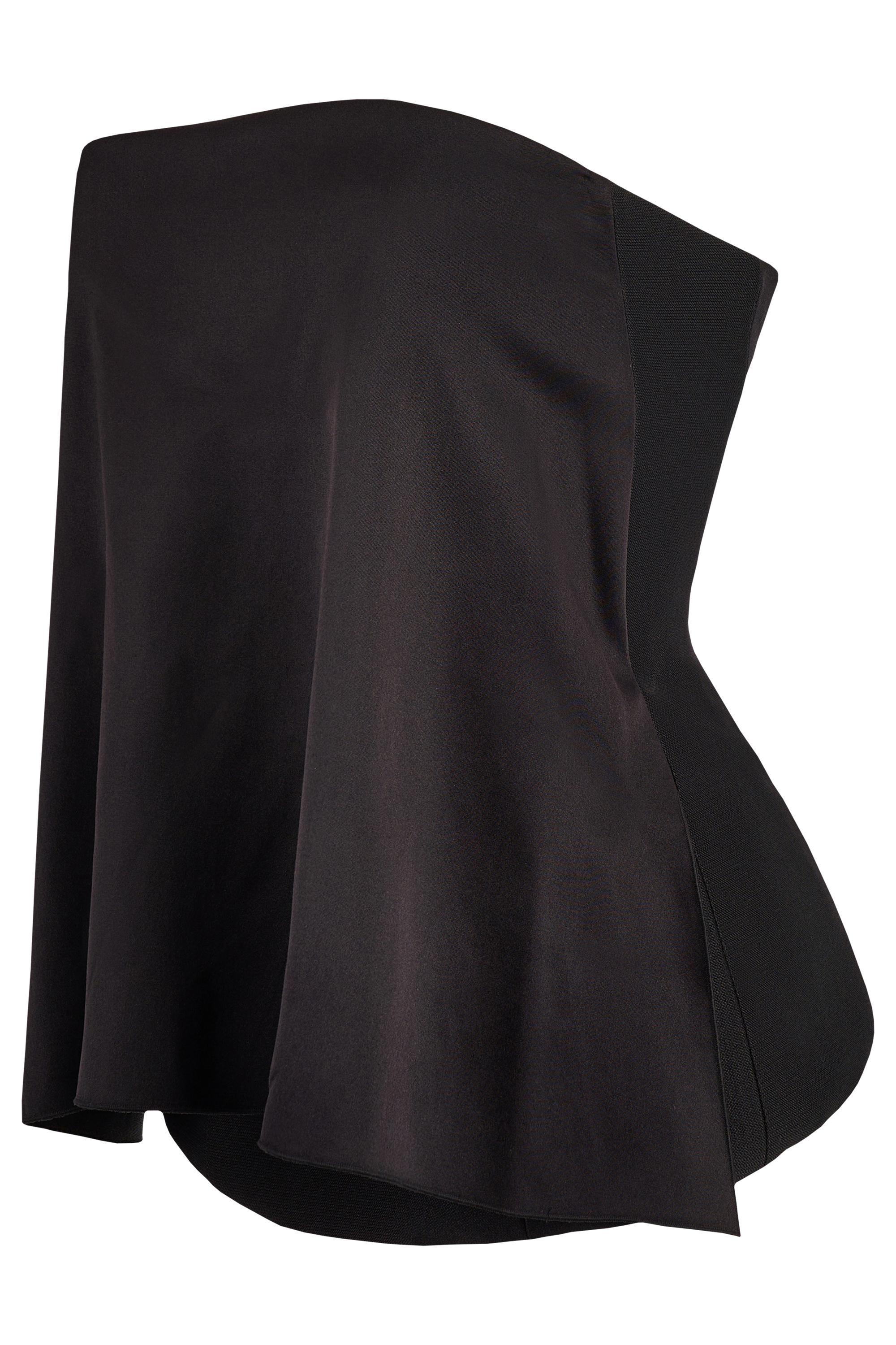 Celine silk corset top features a sculpted silhouette, a black silk fluid fabric at the front, strapless neckline, softly flared overlay that drapes beautifully over a structured knit corset base. Fastens with a back zip . In excellent condition.