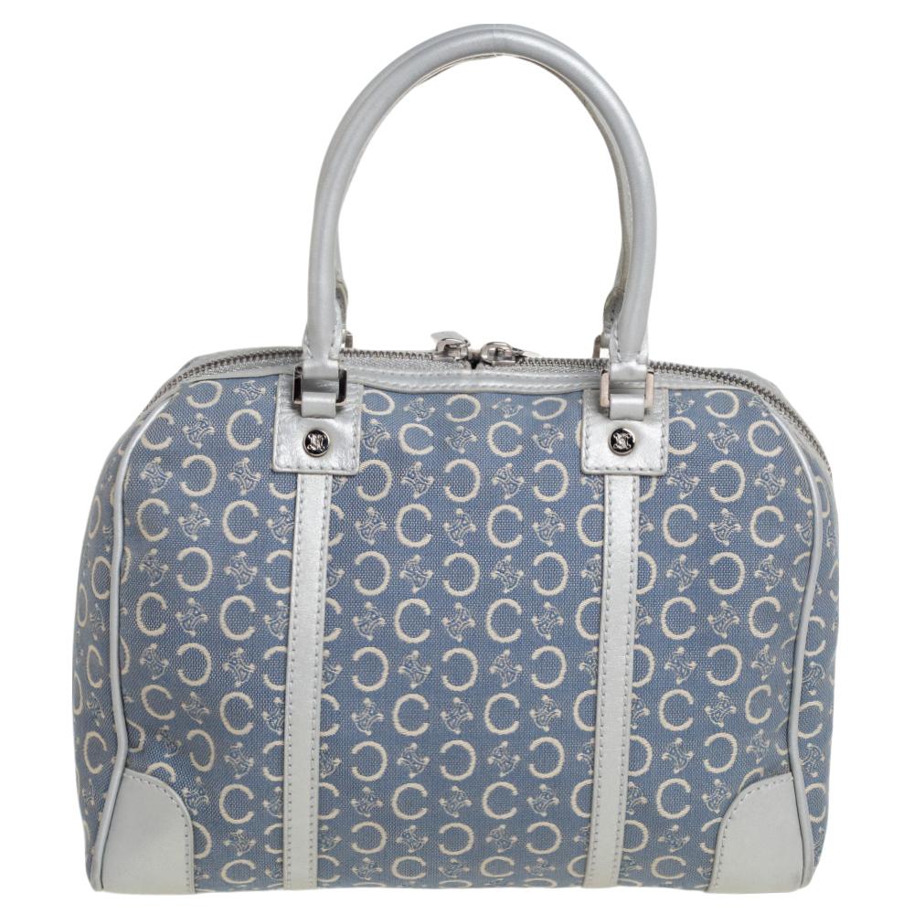 Made from Macadam fabric and leather, this Celine satchel brings a convenient size and a refined appeal. It features two handles, silver-tone hardware, and a fabric-lined interior.

