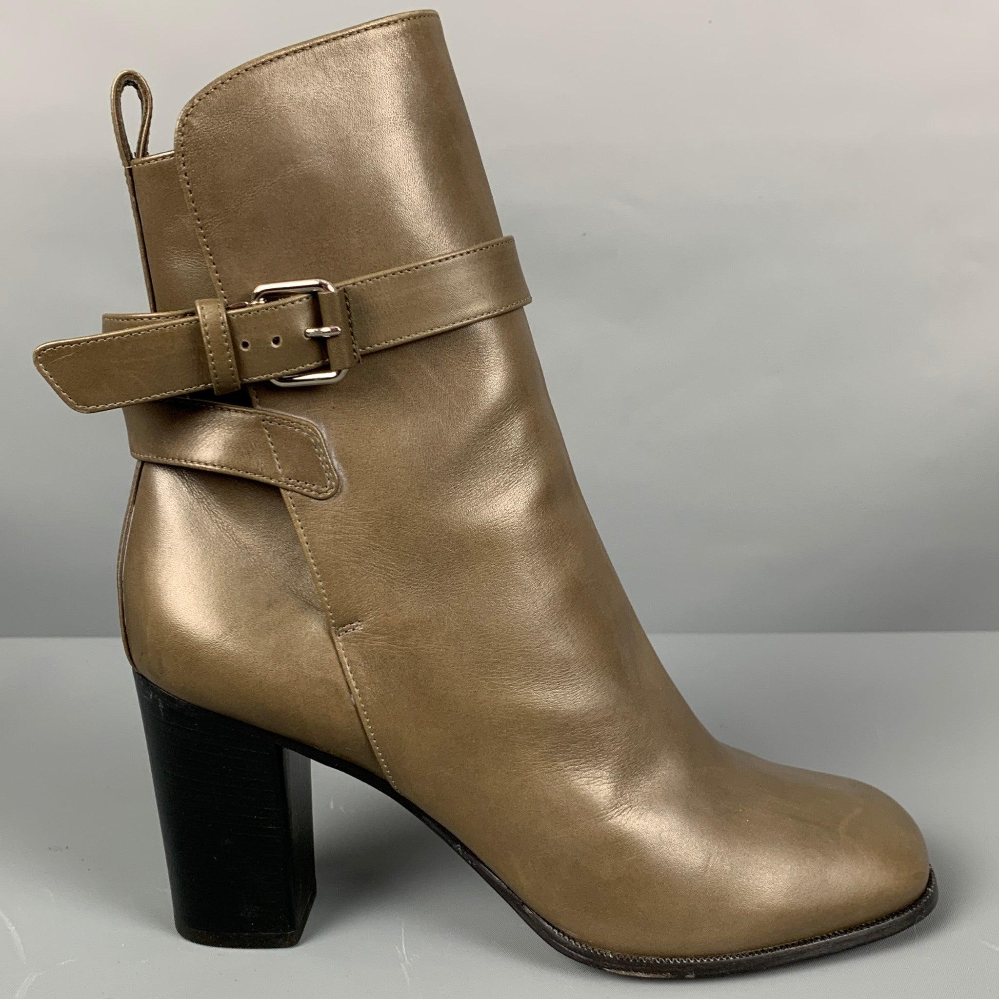 CELINE
boots in a grey leather fabric featuring ankle strap with silver tone hardware, and chunky heel. Made in Italy.Very Good Pre-Owned Condition. Minor signs of wear. 

Marked:   40 

Measurements: 
  Length: 9.25 inches Width: 3.25 inches
