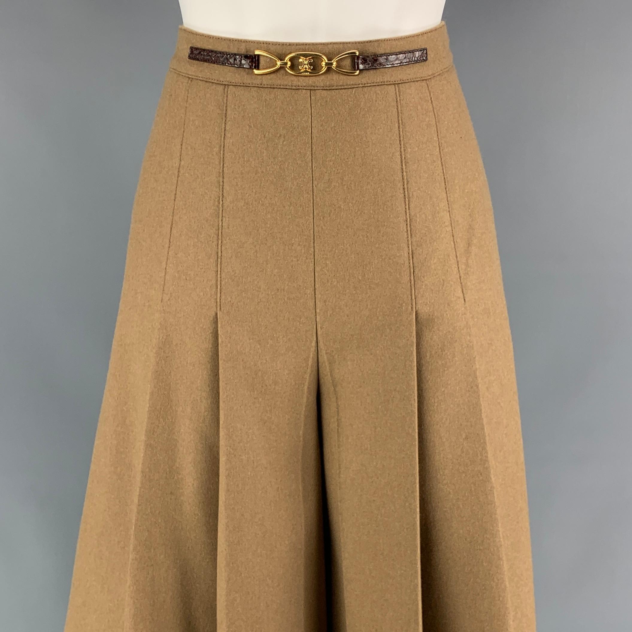 CELINE skirt pants comes in a camel pleated wool with a full liner featuring a alligator leather trim, gold tone hardware detail,high waisted, and a side zipper closure. Made in France. 

Very Good Pre-Owned Condition.
Marked: 36
Original Retail