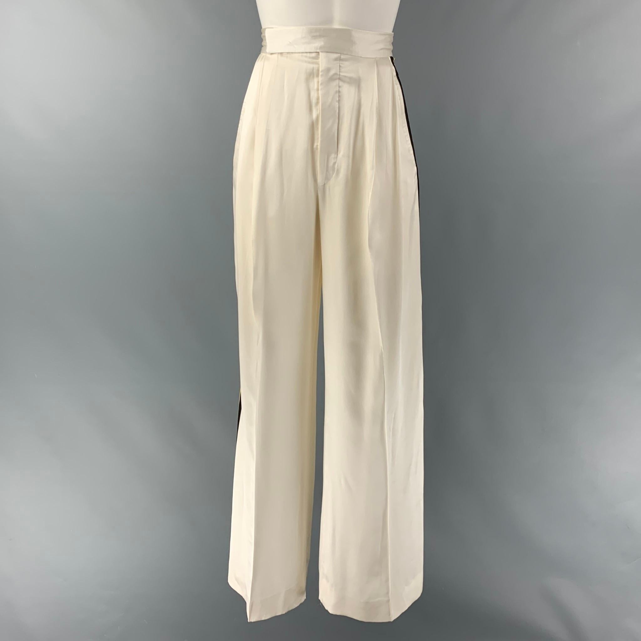 CELINE dress pants comes in a cream silk satin fabric featuring a multi- color trim stripes details, wide leg, high waist, and a front tab and a zip fly closure. Made in Italy.

Excellent Pre-Owned Condition.
Marked: 34

Measurements:

Waist: 24
