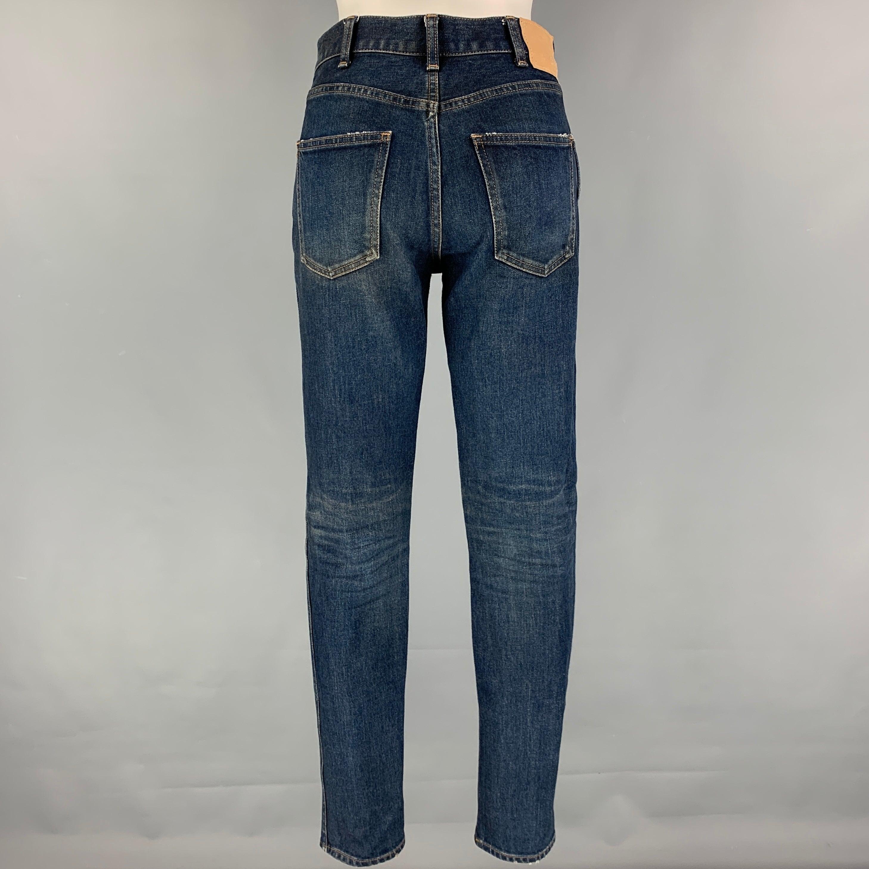 CELINE 'Slim Patch' jeans comes in a dark blue cotton featuring a slim fit, contrast stitching, and a zip fly closure. Made in Japan.
Very Good
Pre-Owned Condition. 

Marked:   26 

Measurements: 
  Waist: 28 inches  Rise: 9.5 inches  Inseam: 30