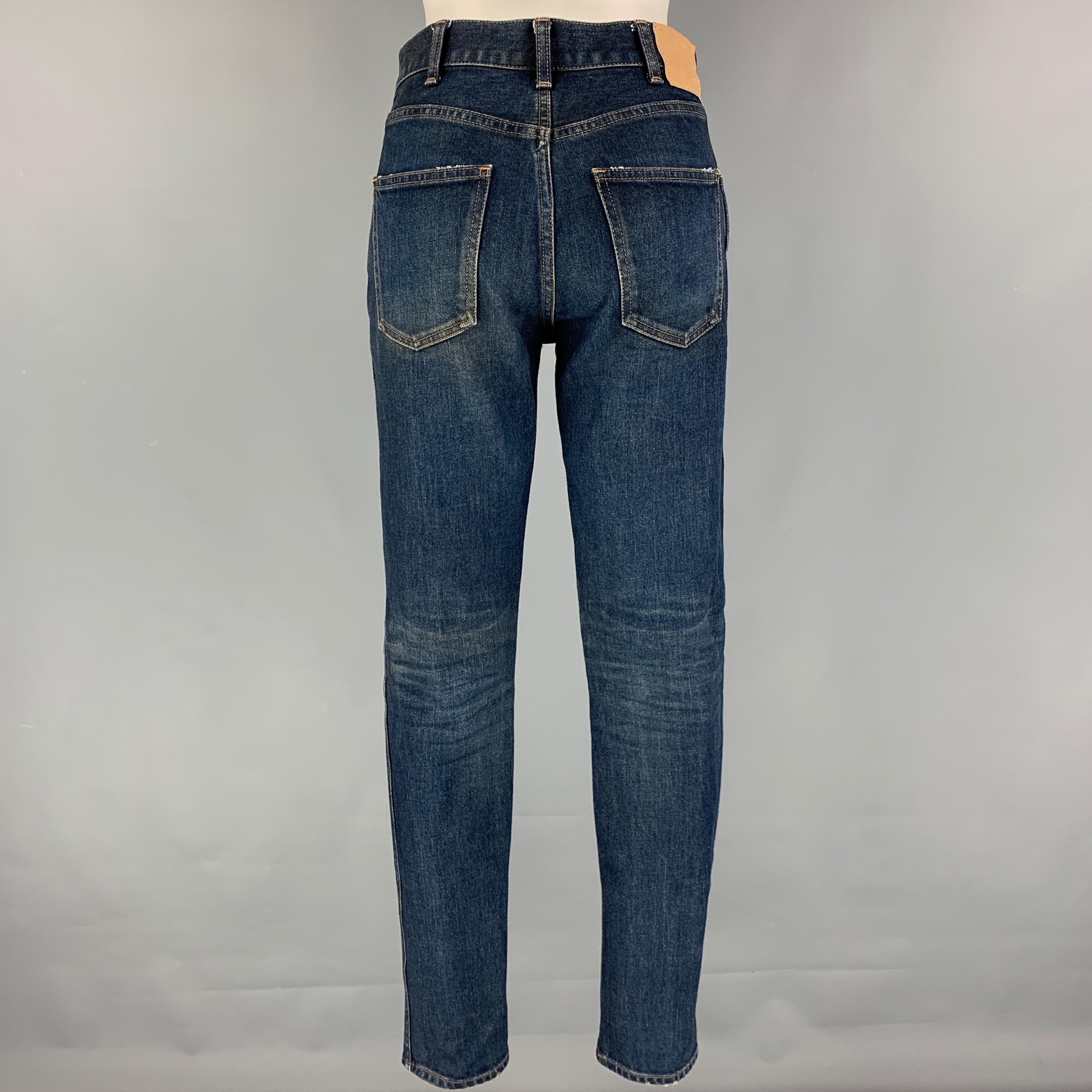 CELINE 'Slim Patch' jeans comes in a dark blue cotton featuring a slim fit, contrast stitching, and a zip fly closure. Made in Japan. 

Very Good Pre-Owned Condition.
Marked: 26
Original Retail Price: $607.00

Measurements:

Waist: 28 in.
Rise: 9.5