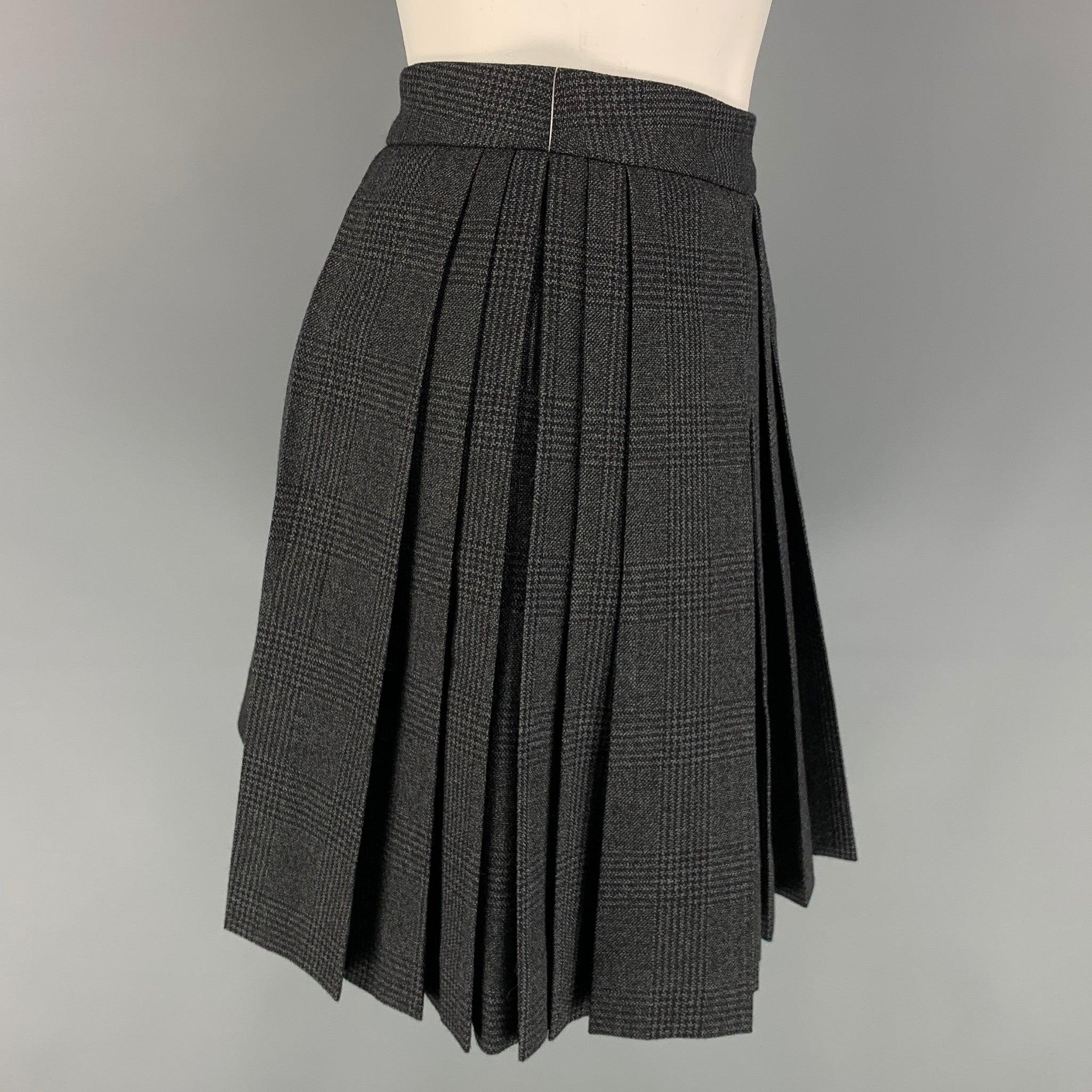 CELINE mini skirt comes in a charcoal plaid wool with a slip liner featuring a pleated style, and a side zip up closure. Made in Italy.
Excellent
Pre-Owned Condition. 

Marked:   36 

Measurements: 
  Waist: 28 inches  Hip: 36 inches  Length: 16