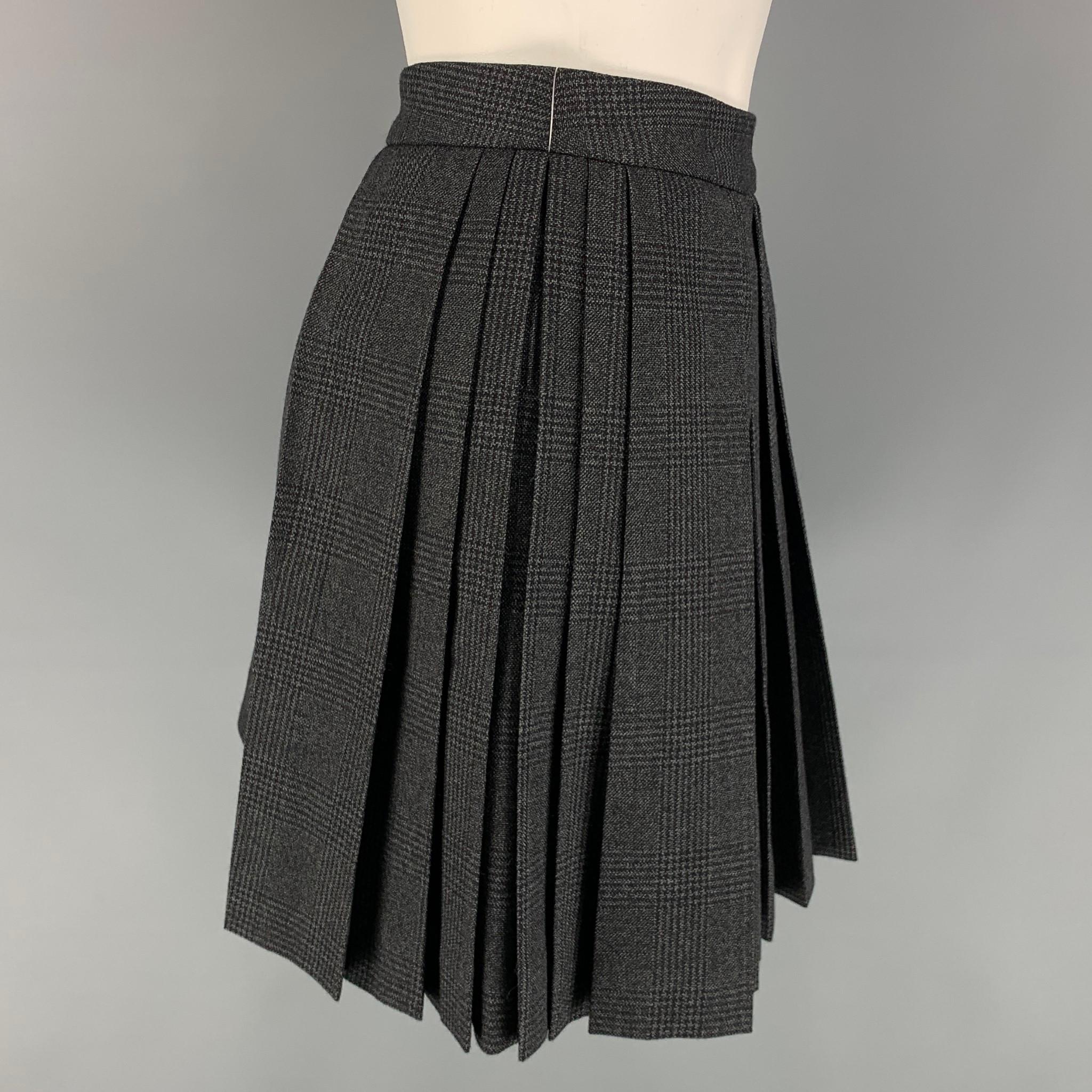 CELINE mini skirt comes in a charcoal plaid wool with a slip liner featuring a pleated style, and a side zip up closure. Made in Italy. 

Excellent Pre-Owned Condition.
Marked: 36
Original Retail Price: $1,350.00

Measurements:

Waist: 28 in.
Hip: