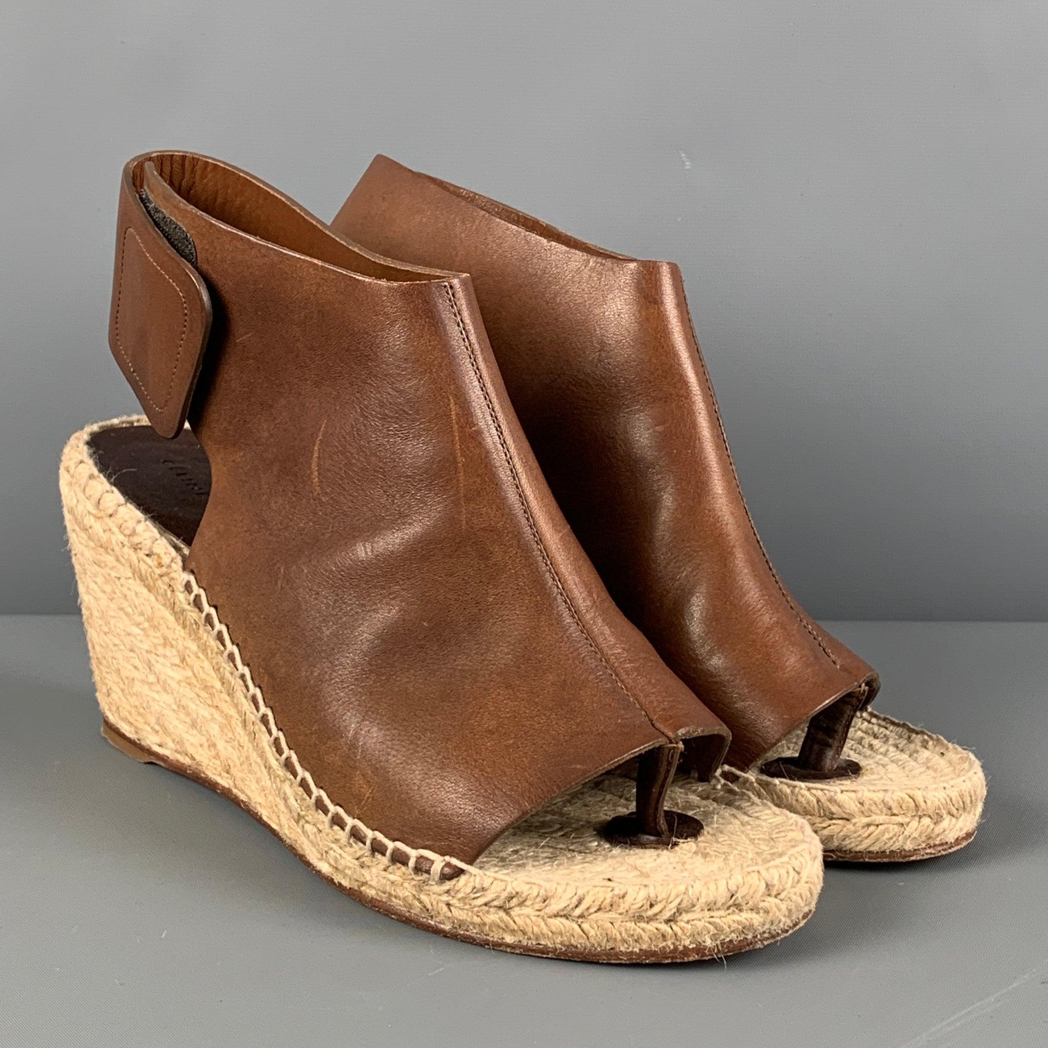 CELINE sandals comes in a tan leather featuring a natural rope trim, open toe, hook & loop, and a wedge heel.
Very Good
Pre-Owned Condition. 

Marked:   37 

Measurements: 
  Heel: 3.25 inches 
  
  
 
Reference: 123111
Category: Sandals
More