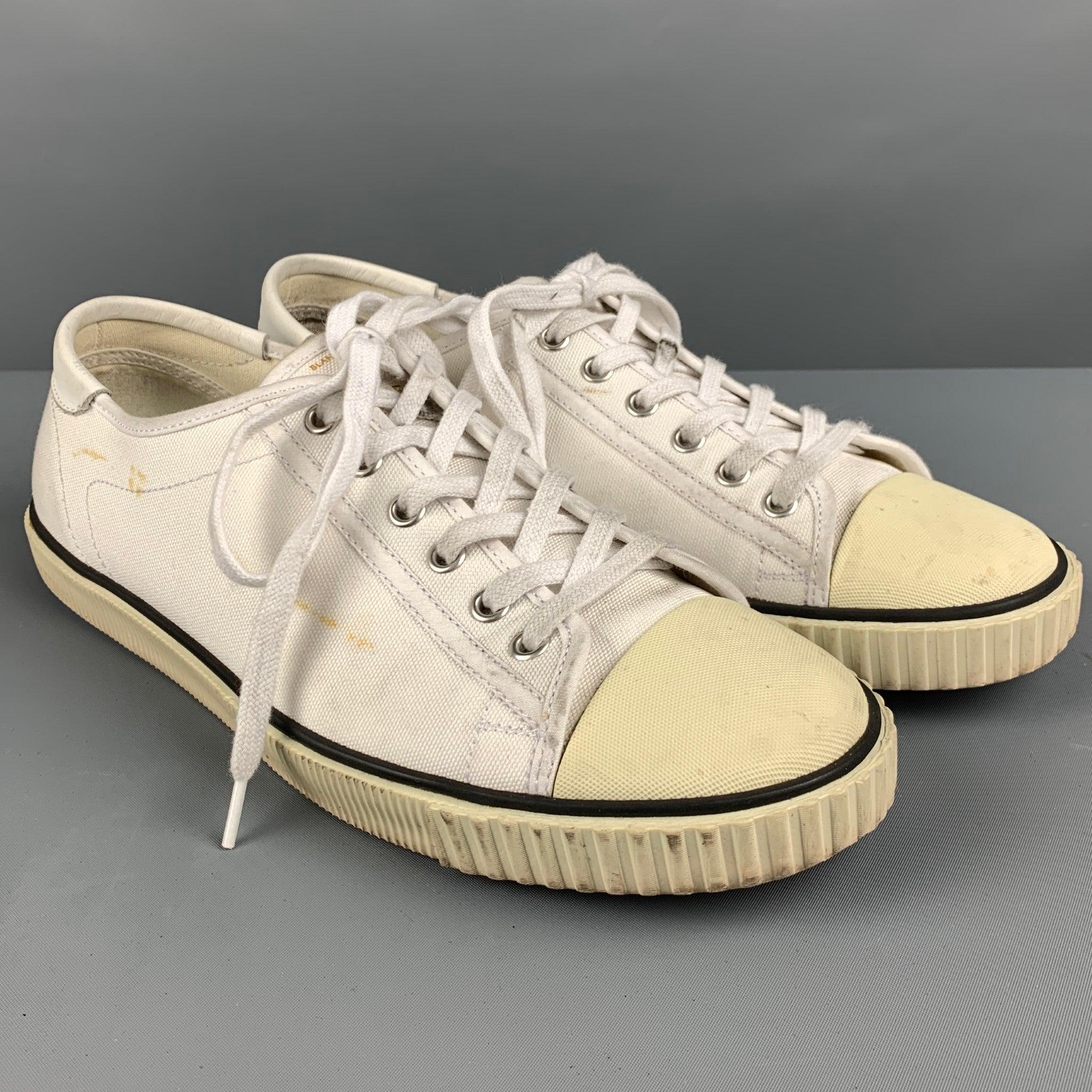 CELINE sneakers
in a white canvas fabric featuring a black trim, rubber tip, and lace up closure. Comes with box.Good Pre-Owned Condition. Moderate signs of wear, please check photos. As is. 

Marked:   8Outsole: 11 inches  x 4 inches  
  
 