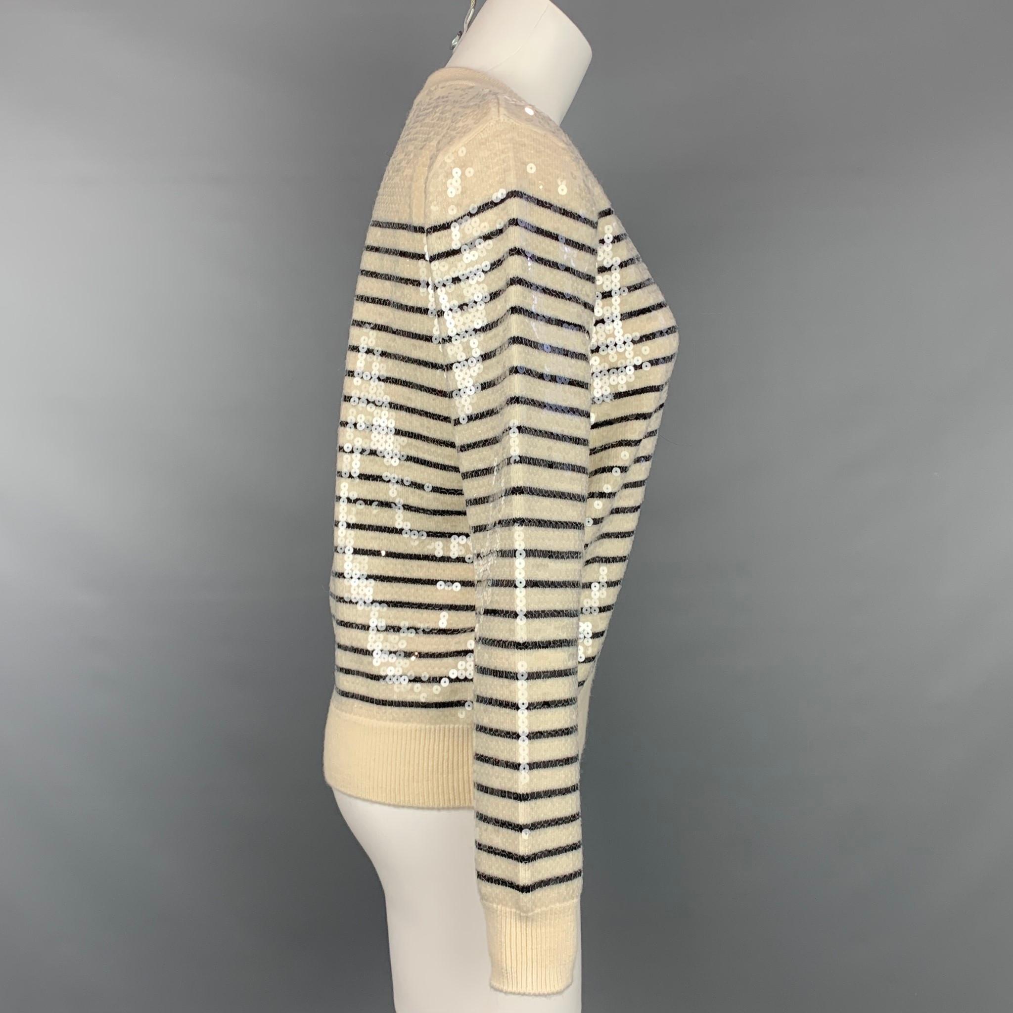 CELINE sweater comes in a cream sequined stripe wool featuring a ribbed hem, side buttons, and a crew-neck. Made in Italy.

Very Good Pre-Owned Condition.
Marked: S
Original  Retail Price: $2,200.00

Measurements:

Shoulder: 16.5 in.
Bust: 35