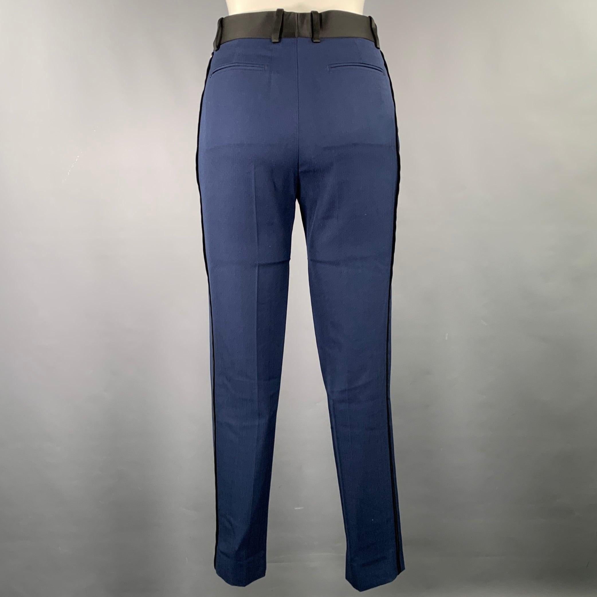 CELINE dress pants
in a navy wool fabric featuring black side stripes and waist, straight leg, and zip fly closure. Made in Italy.Very Good Pre-Owned Condition. Moderate marks inside of garment. 

Marked:   IT 34 

Measurements: 
  Waist: 30 inches
