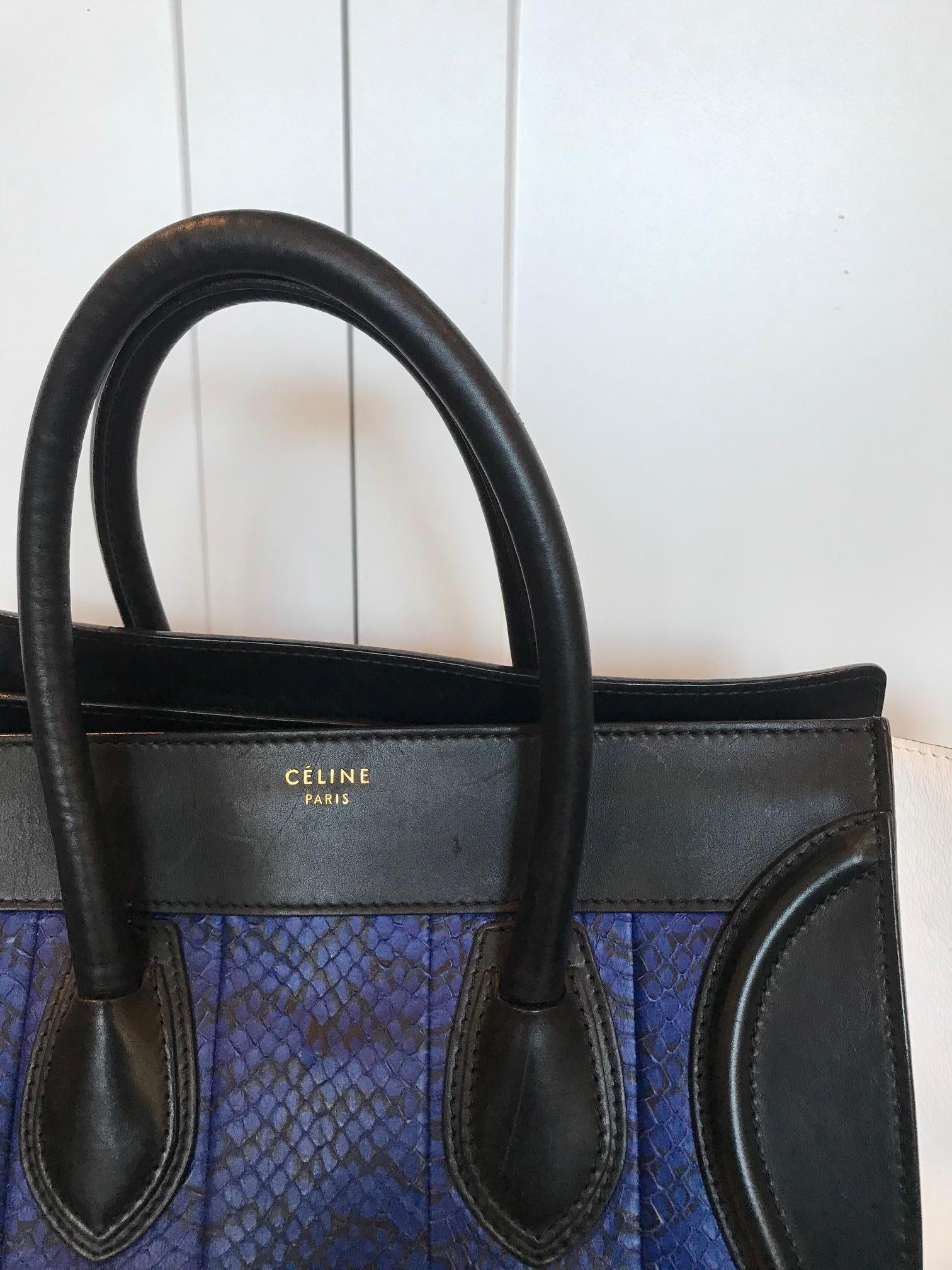 Royal blue leather and black and white skin. Featuring black double top handles. Silver-tone hardware. The bottom comes secured with silver-tone studs. The exterior has a zipper pocket at the front. The top zipper closure opens to an accommodating