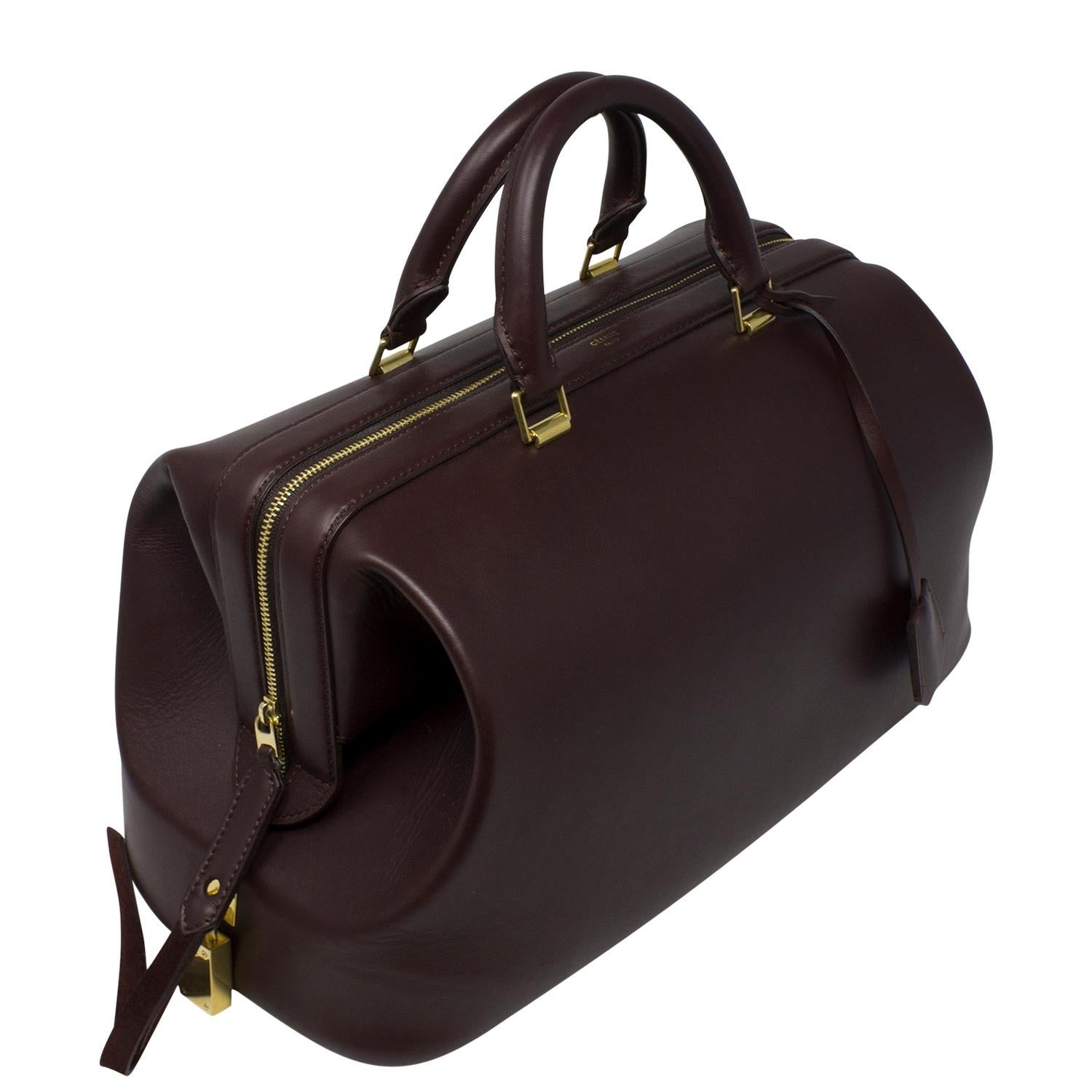 This piece is so elevated and elegant and boasts the superior quality of the Celine house. This is a very well crafted bag in a classic doctor bag silhouette in a rich burgundy tone and features smooth top handles, a wrap around zipper and four