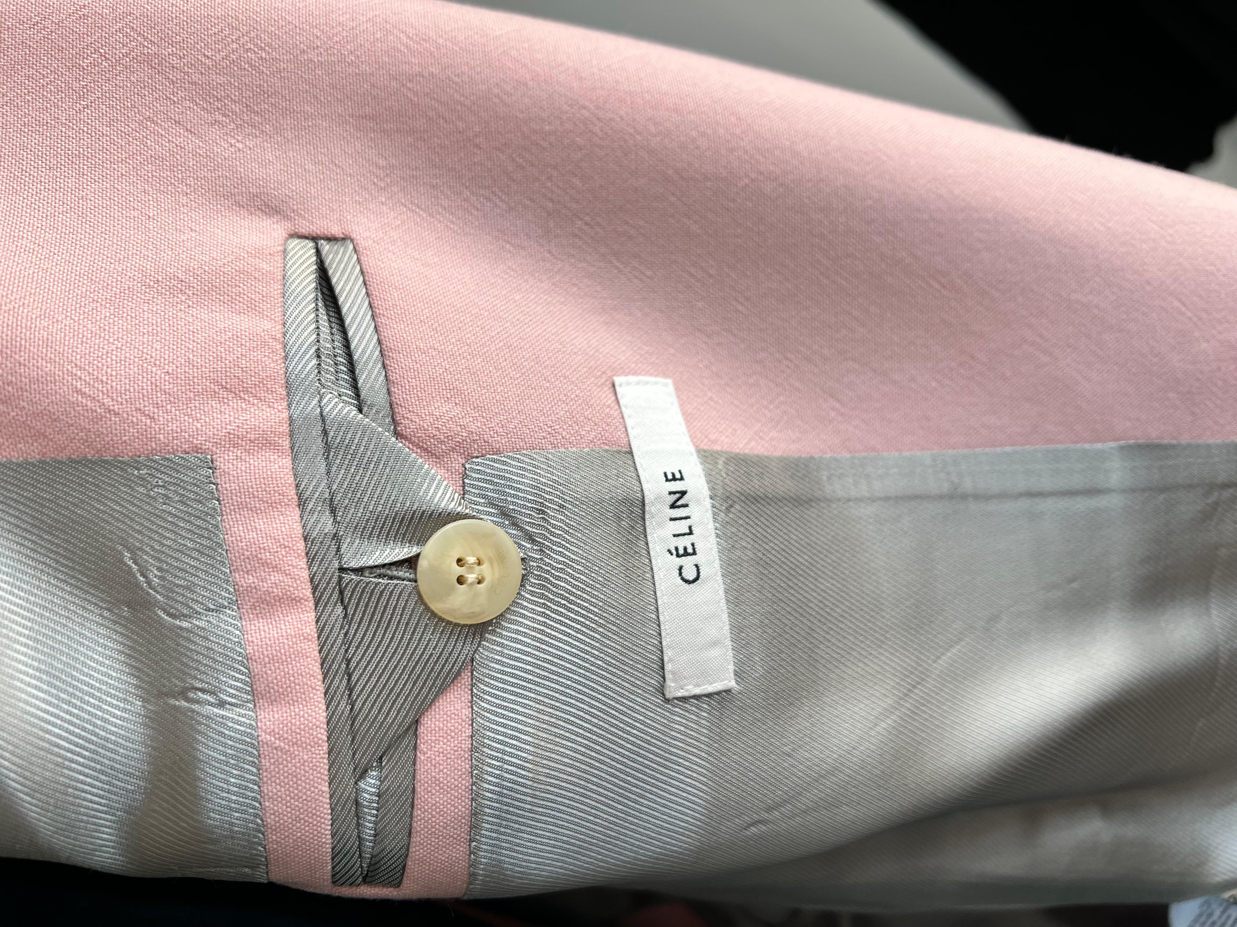 The long tailored jacket in blush pink light wool tailoring features a short notched lapel collar, padded shoulders, and a martingale belt. A slit on the back helps prevent the fabric from bunching even with the martingale buttoned

Condition: