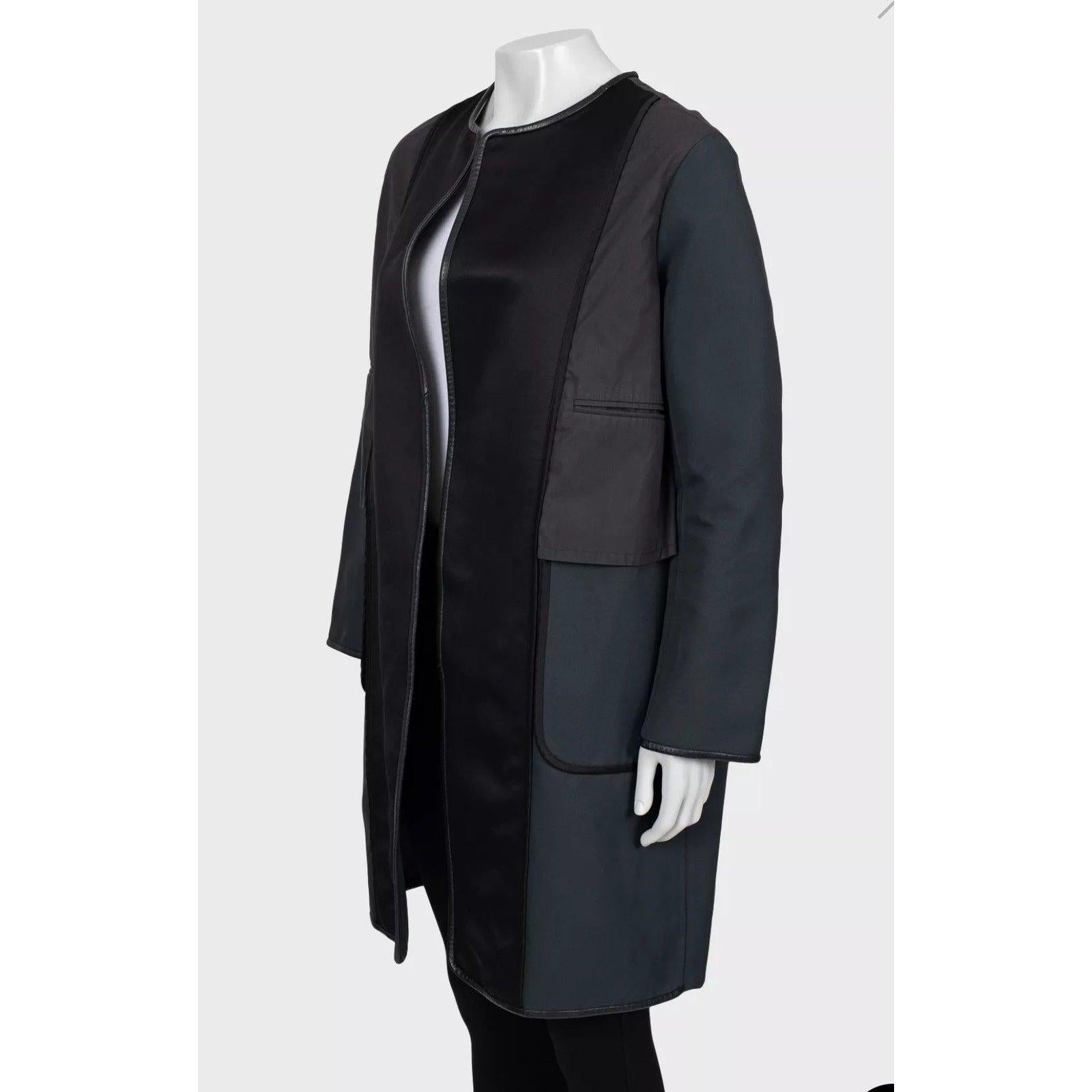 Eleva il tuo guardaroba con questo splendido cappotto di Celine dal taglio dritto, un capo d'abbigliamento raro e lussuoso che fonde perfettamente la sartoria minimalista con audaci dettagli in pelle. Perfetto per i collezionisti e gli appassionati