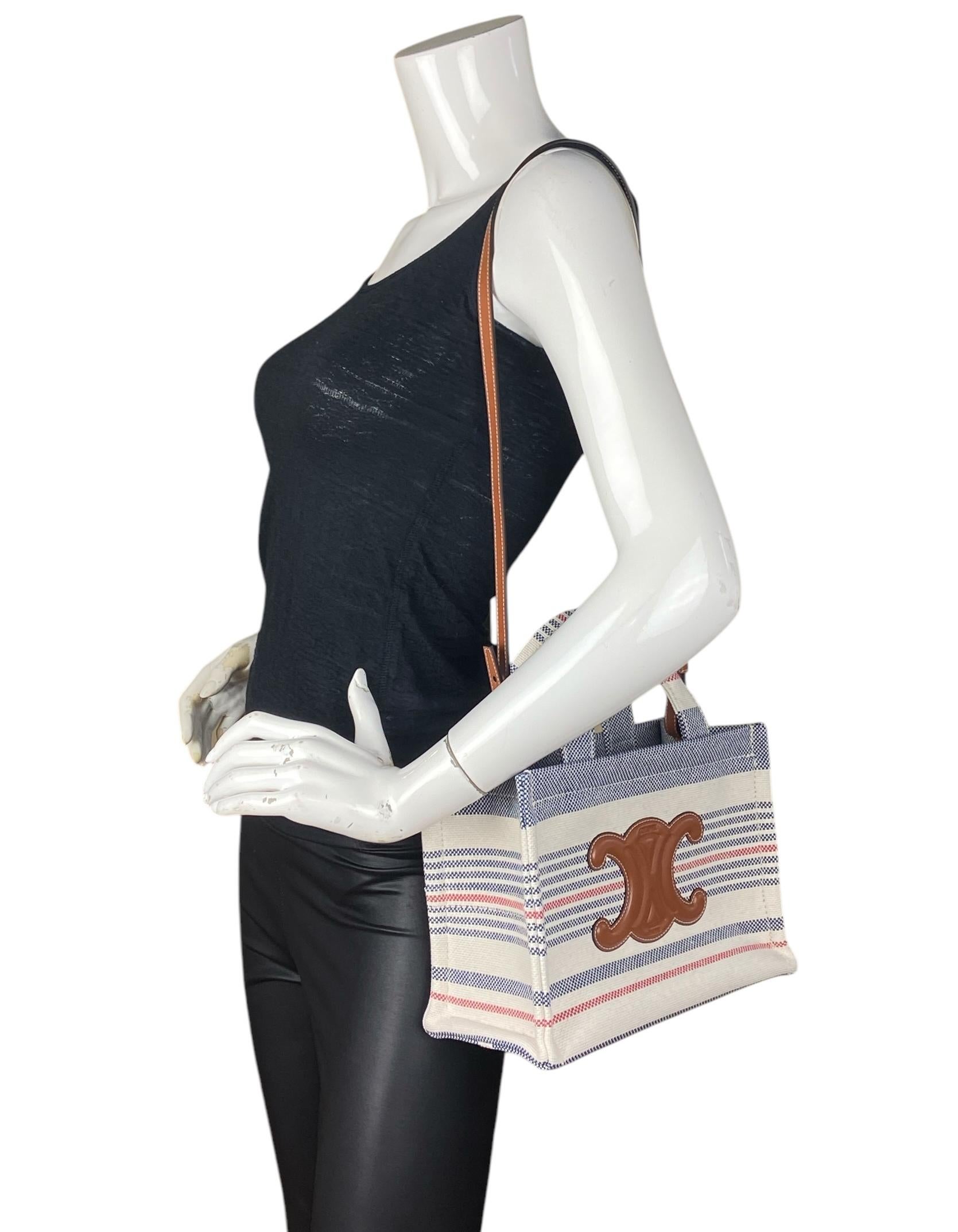 Celine Striped Canvas Small Cabas Thais Bag w/ Calfskin Triomphe. Features Long strap allowing for crossbody wear. 

Made In: Italy
Year of Production: 2025
Color: Blue, white, red, brown
Hardware: Silvertone
Materials: Textile and calfskin