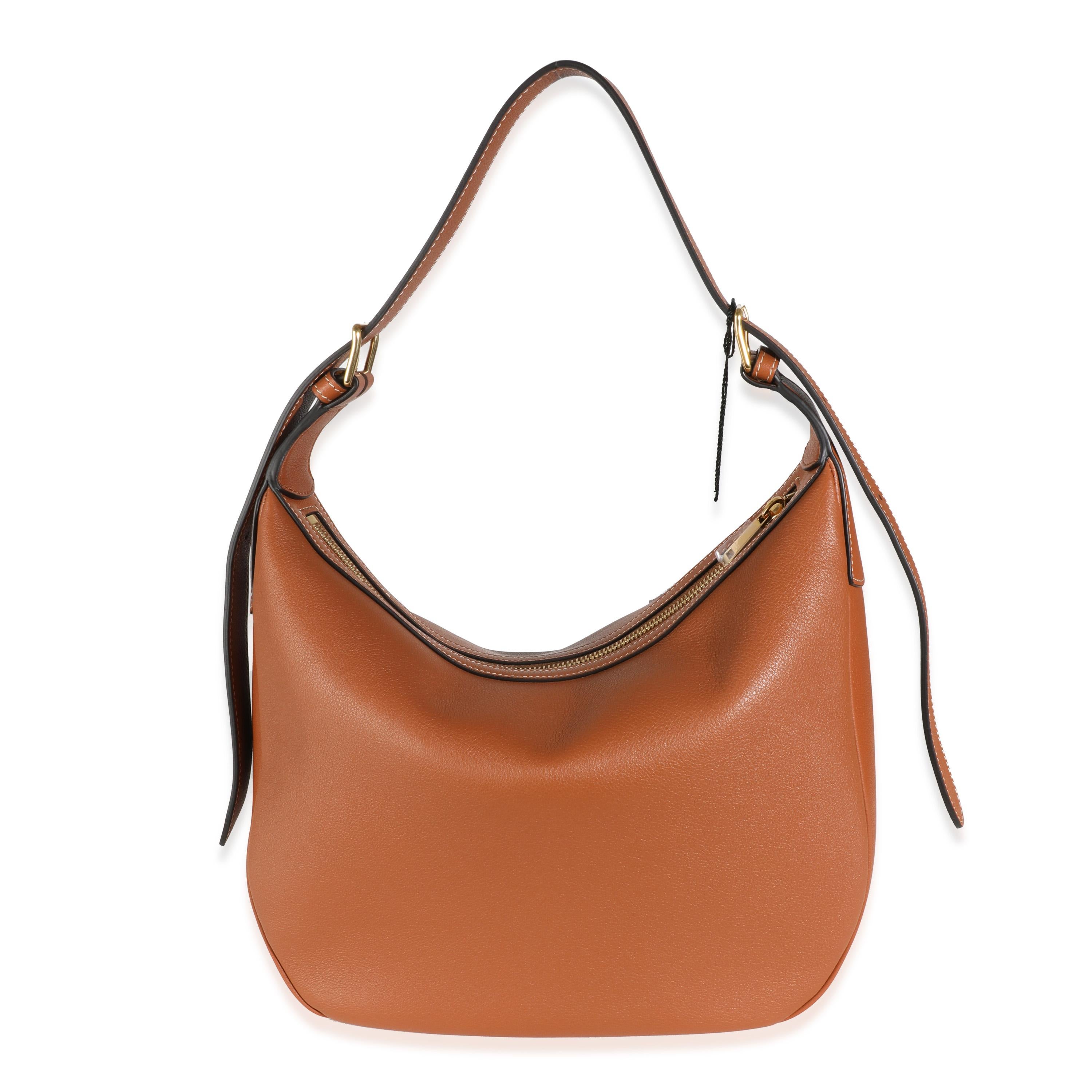 Listing Title: Celine Tan Supple Calfskin Medium Triomphe Heloise Bag
SKU: Z143974
MSRP: 3450.00 USD
Condition: Pre-owned 
Handbag Condition: Pristine
Condition Comments: Item has no indication of wear. Final sale.
Brand: Celine
Model: