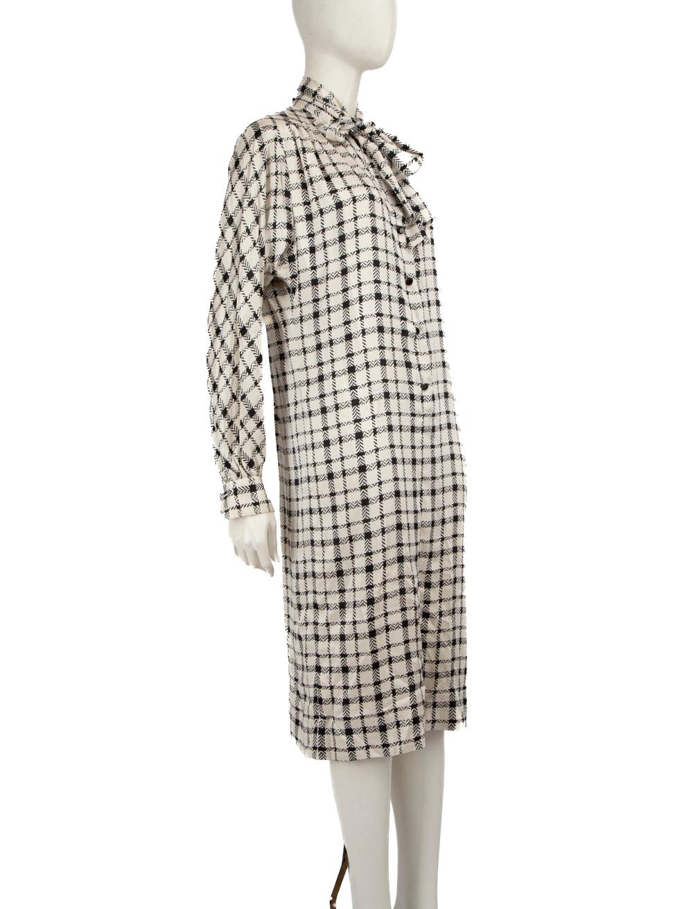 CONDITION is Good. Minor wear to dress is evident. Light signs of marks to front of skirt. Minor pull to weave on the front hemline. The interfacing inside the shoulder pads has disintegrated and the buttons along the centre front are becoming