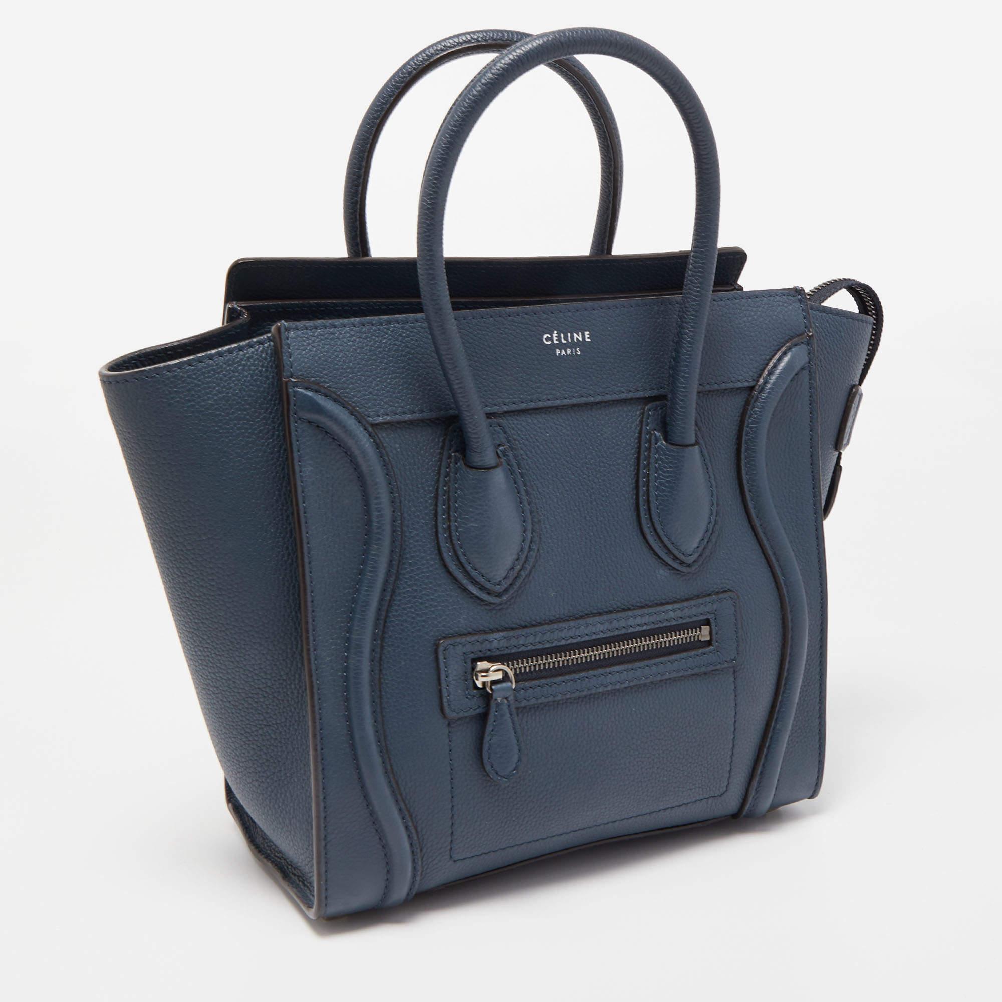 The Luggage tote from Celine is one of the most popular handbags in the world. This tote is crafted from leather and designed in a teal blue hue. It comes with rolled top handles and a front zip pocket. The bag is equipped with a well-sized leather