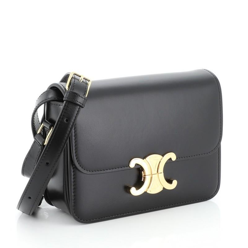 This Celine Teen Triomphe Shoulder Bag Smooth Calfskin, crafted in black leather, features leather shoulder strap, a front gold press lock and gold-tone hardware. It opens to a black leather interior divided into three compartments with zip and slip