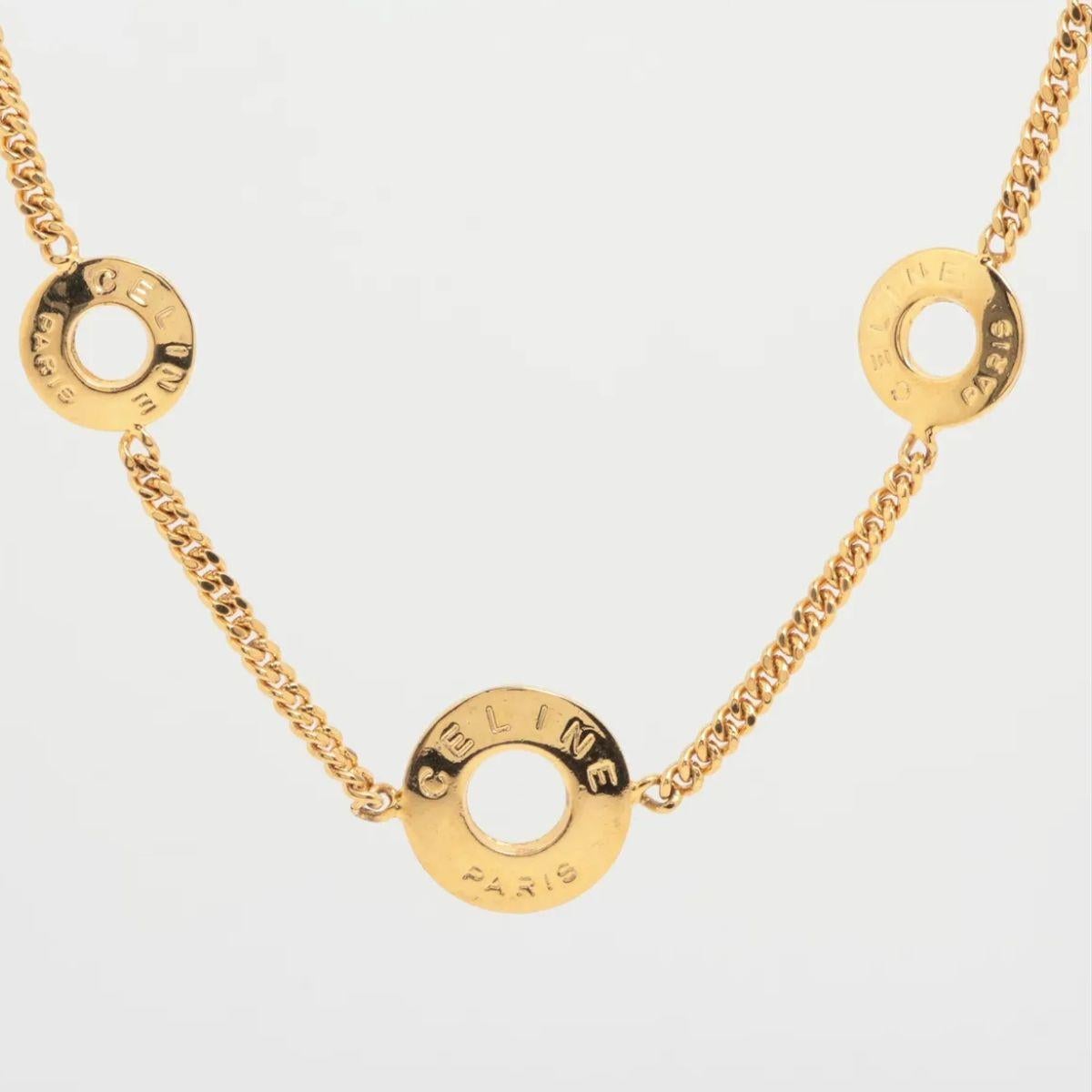 The Celine Three Round Logo Necklace is a minimalist yet elegant piece that embodies the brand’s understated luxury. Crafted in a gold-tone finish, the necklace features three delicate circular pendants, each engraved with the iconic Celine logo,