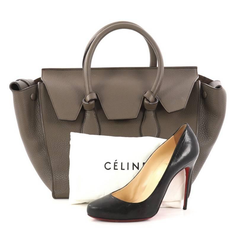 This authentic Celine Tie Knot Tote Grainy Leather Small is an absolute must-have for serious fashionistas. Crafted from taupe grainy leather, this boxy chic tote features dual-rolled leather handles with signature knot accents, expandable wings and