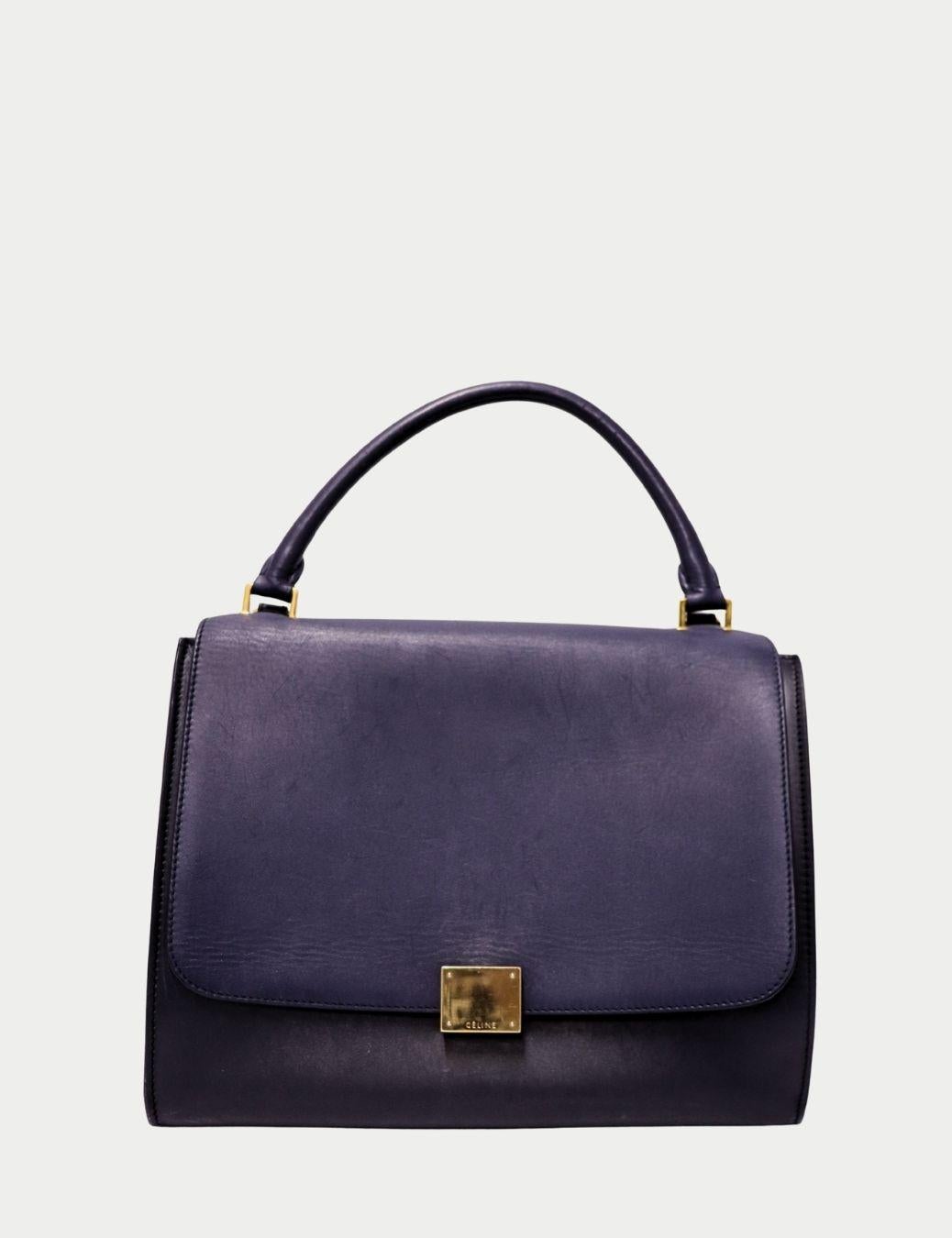 Celine Trapeze Navy Leather Top Handle Bag

Elevate your everyday style with this sophisticated Celine navy leather top-handle bag, crafted in the brand’s signature minimalist aesthetic. This structured flap-style design features smooth premium
