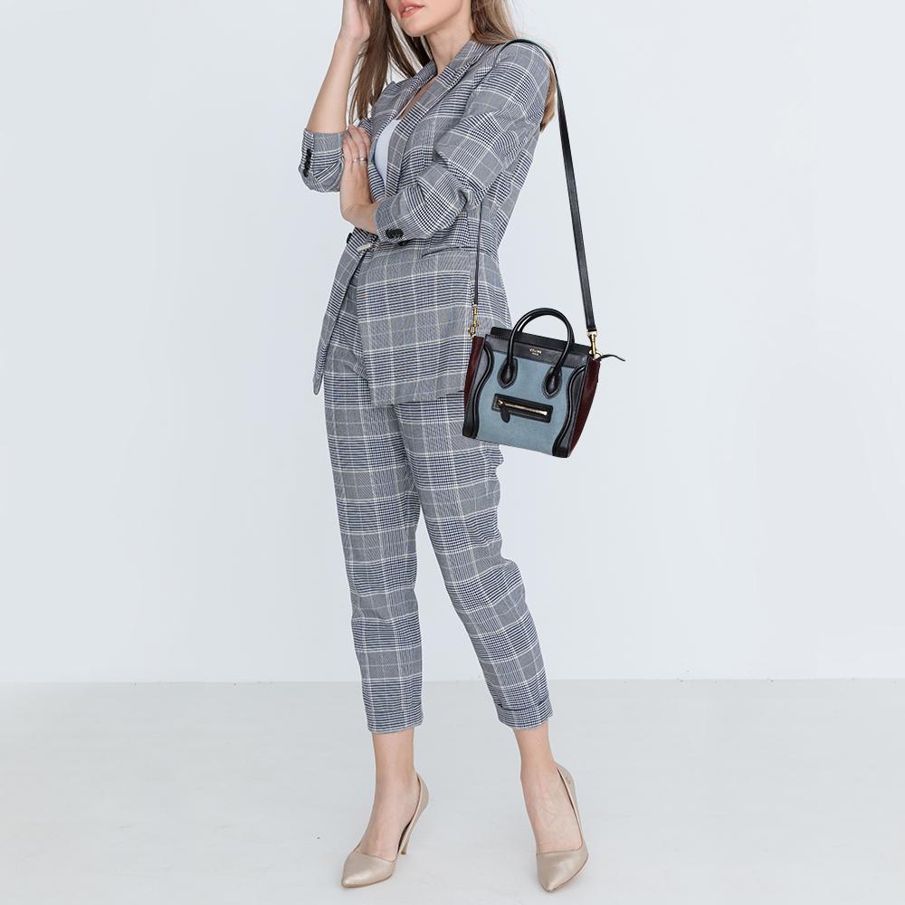 The mini Luggage tote from Celine is one of the most popular handbags in the world. This tote is crafted from calf hair and leather and designed in a tricolor palette. It comes with rolled top handles and a front zip pocket. The bag is equipped with