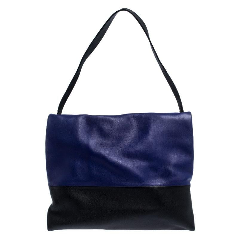 Minimalist charm for the everyday woman reigns the chic brand, Céline. This Celine All Soft shoulder bag with a neutral and understated look perfect for the modern woman. Crafted from blue, black and grey-colored leather, this minimalist tote