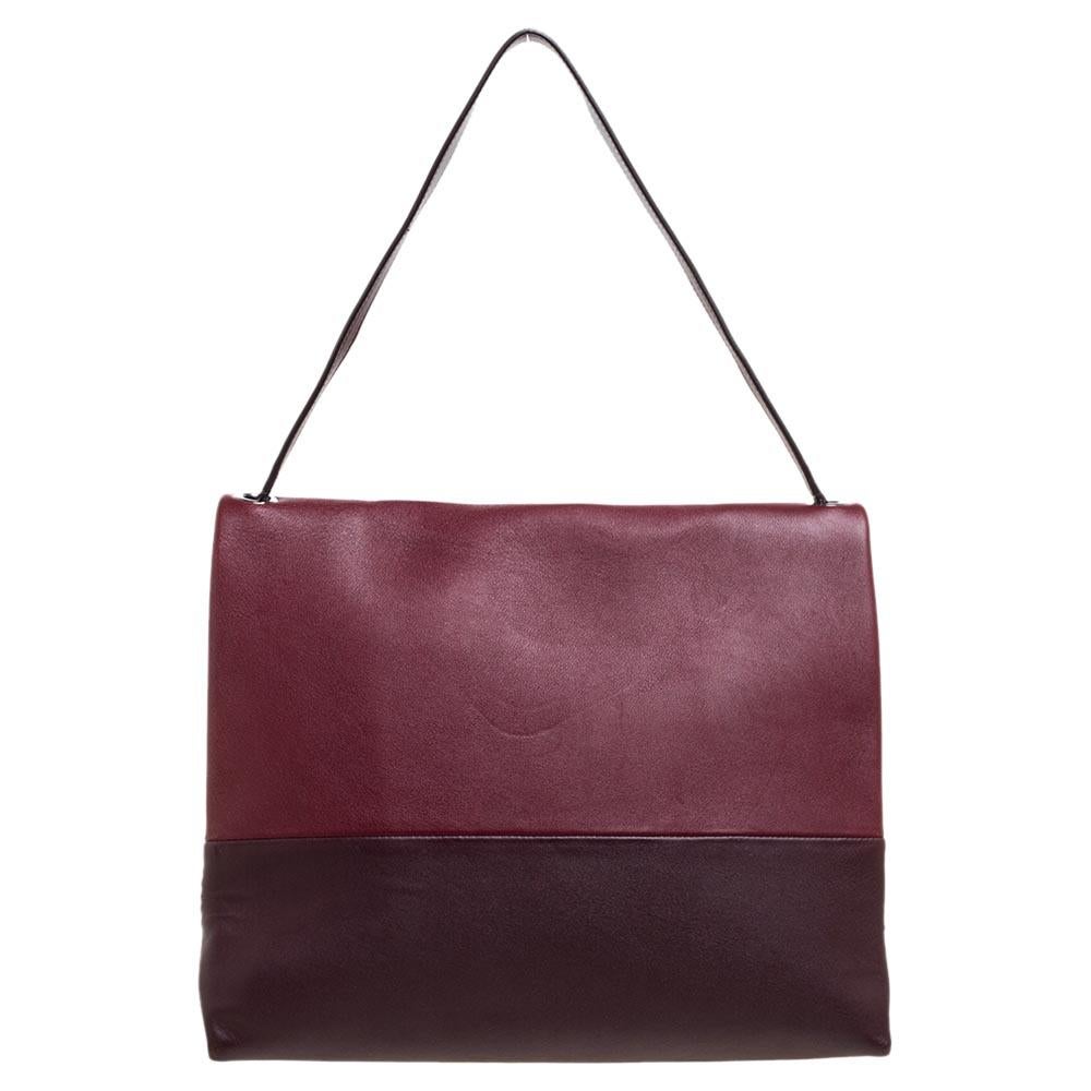 This beauty comes from the house of Celine. It has been crafted from leather and suede in multiple shades and equipped with a shoulder strap and a capacious leather interior that will hold all your essentials and much more. Simple in design and high