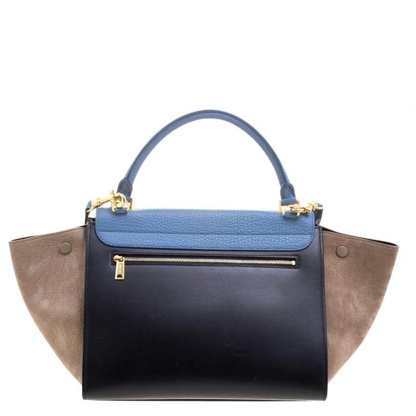 Featuring a chic, yet luxurious style, this Celine bag is distinctive. Crafted from tri color leather, this tote features signature flappy wings, gold tone hardware and a zip pocket at the rear. The front flap opens to a spacious leather lined