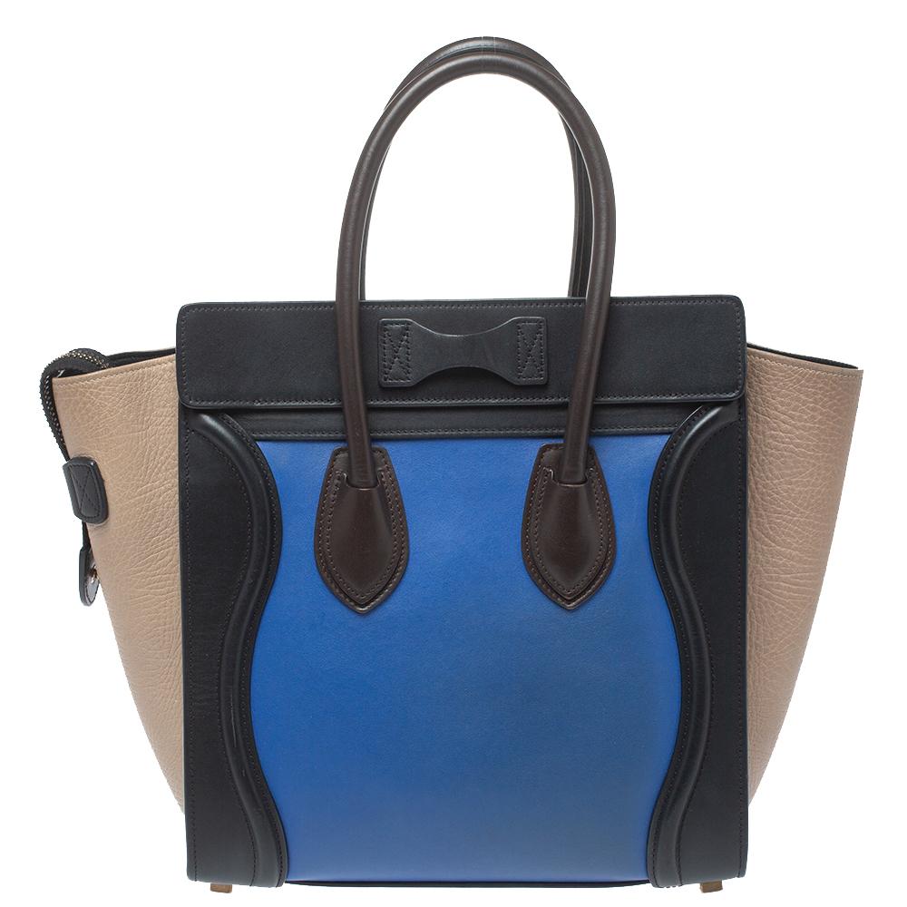 This Celine Luggage tote is stylish and perfect for everyday use. Crafted from leather in three different hues, it features the signature flappy wings, double rolled handles, and a front zip pocket. The top zip closure opens to a perfectly sized