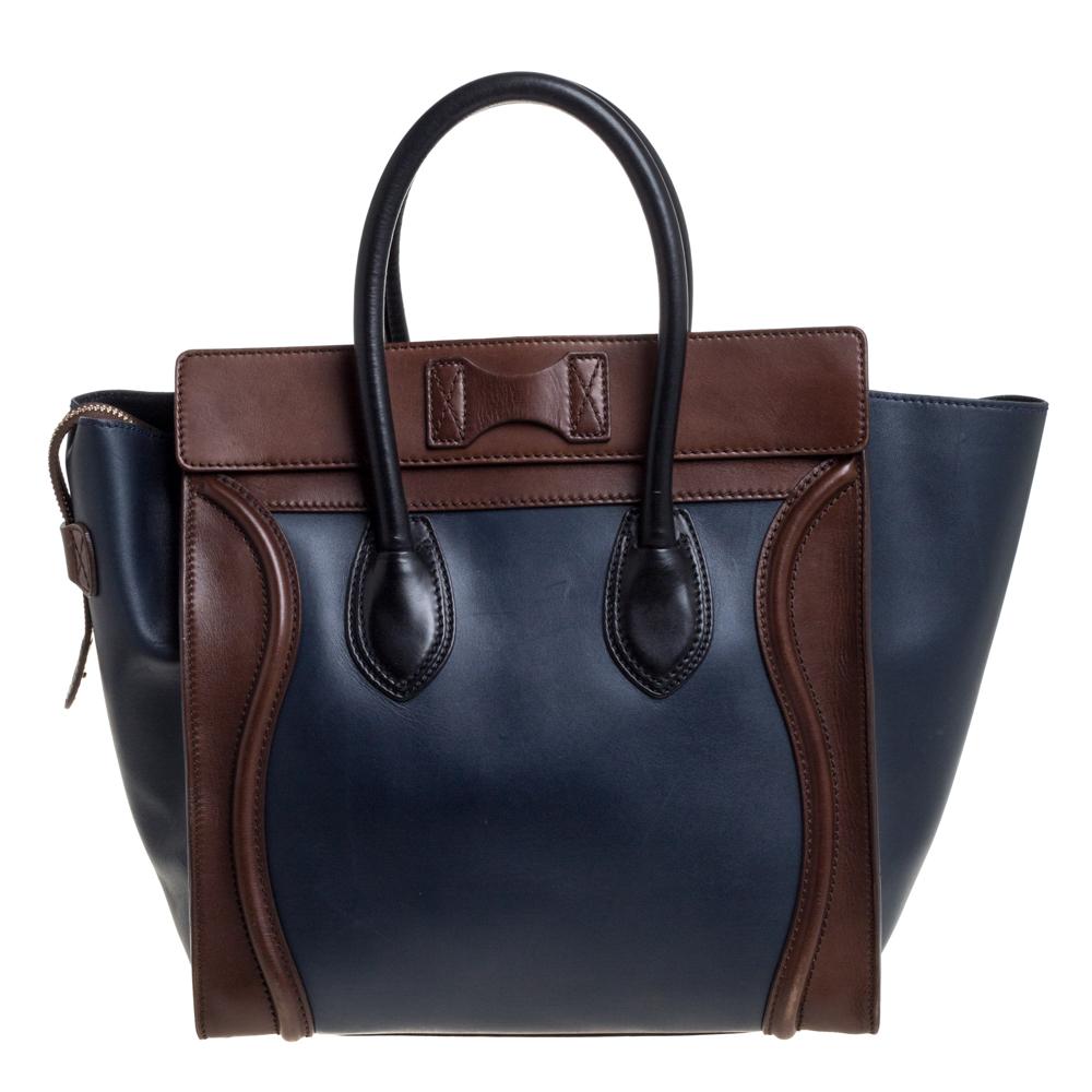 The mini Luggage tote from Celine is one of the most popular handbags in the world. This tote is crafted from leather and designed in a tricolor palette. It comes with rolled top handles, protective metal feet, and a front zip pocket. The bag is