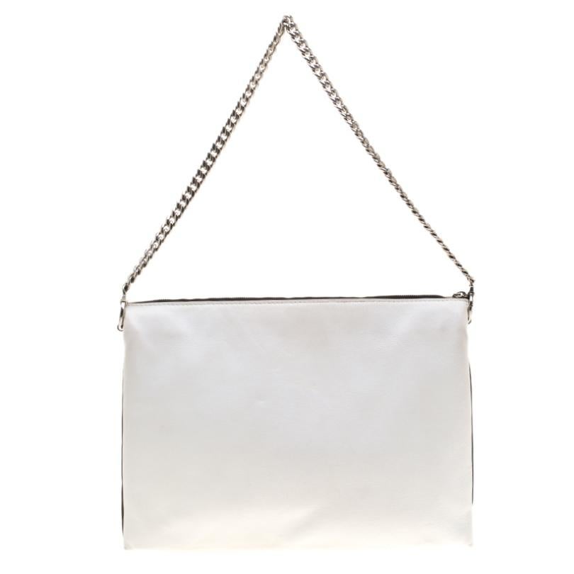 This minimalist yet beautiful clutch from the house of Celine is both, elegant and organized. Crafted from soft leather, this bag is has a blushed pink front with a white back and black contours. It is accented with a silver-tone chain shoulder