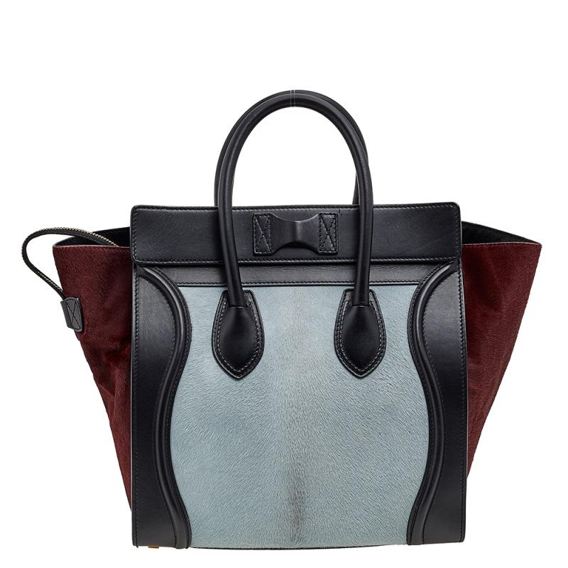 The mini Luggage tote from Celine is one of the most popular handbags in the world. This tote is crafted from calf hair and leather and designed in three shades. It comes with rolled top handles and a front zip pocket. The bag is equipped with a