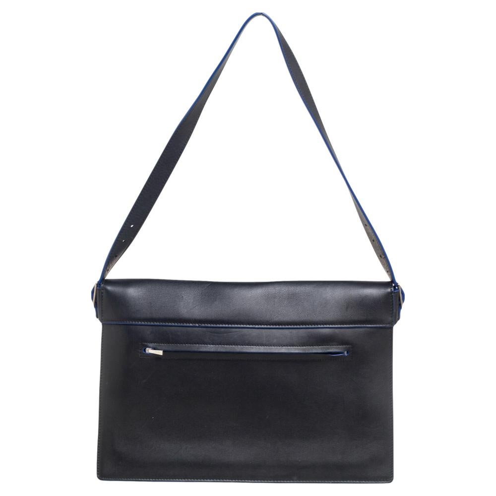 Crafted in tricolor leather and suede, this beautiful Diamond shoulder bag from Celine is easy to carry with casuals or formals. The envelope front flap opens with a silver-tone lock closure to a leather-lined interior with different compartments to