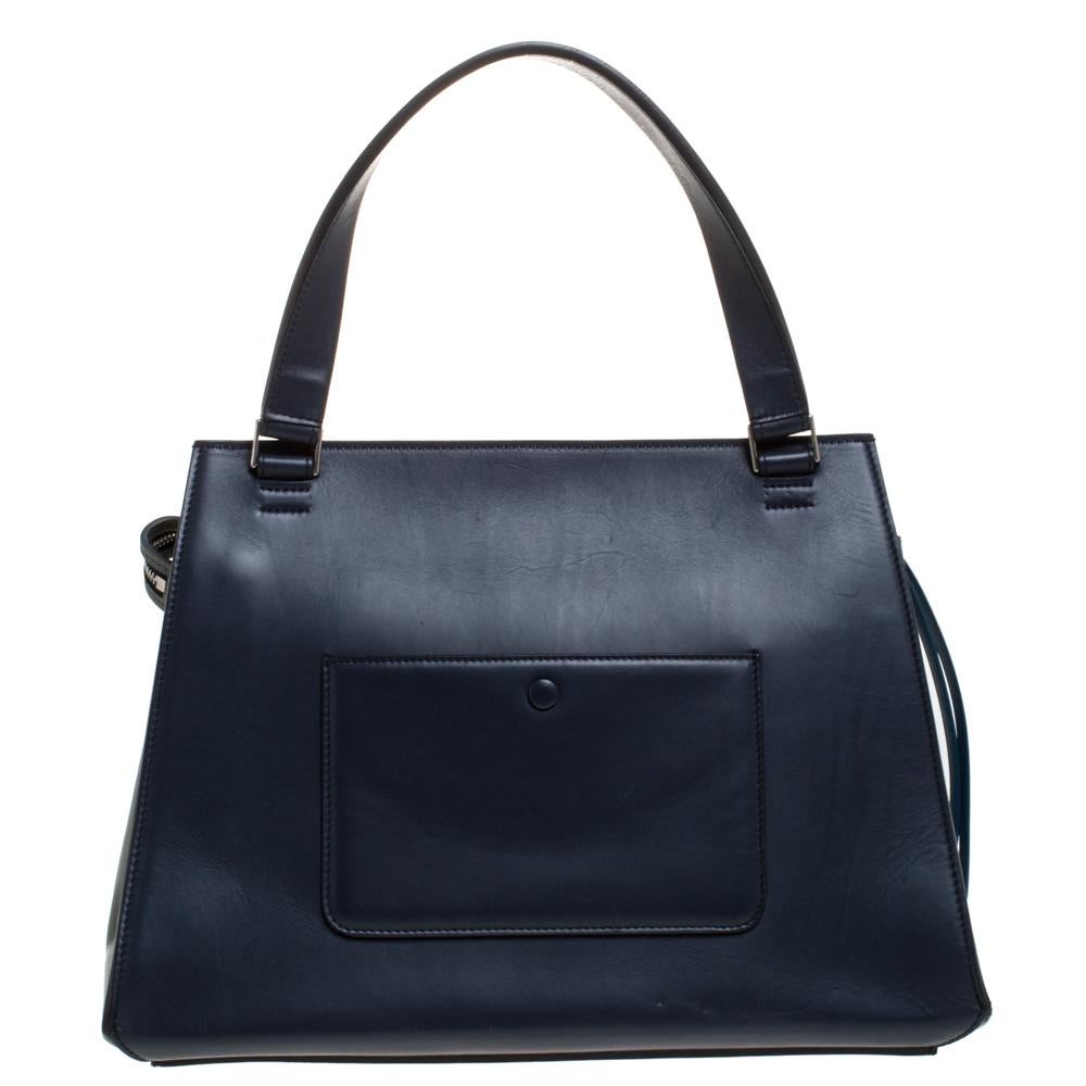 This Celine Edge bag is not only visually magnificent but also functional. It has been crafted from leather and styled with a silhouette that is classy and posh. The subtly-hued bag has a top handle and a top zipper that reveals a spacious interior.