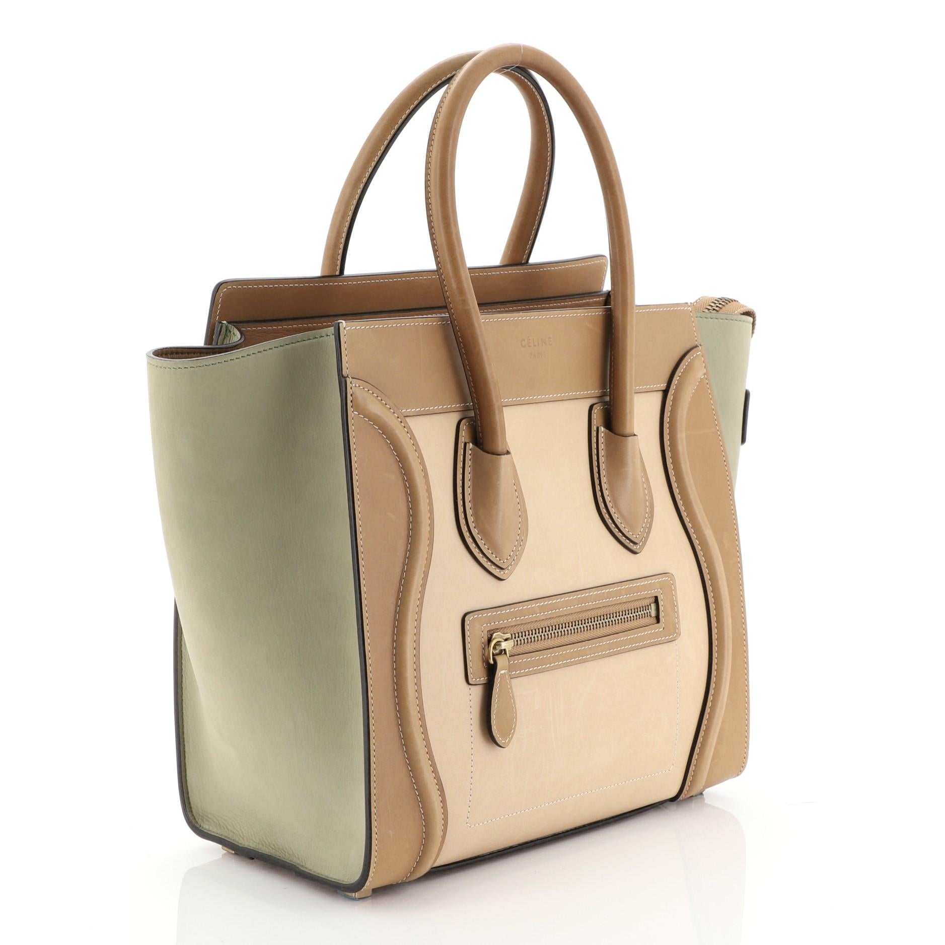 This Celine Tricolor Luggage Handbag Leather Micro, crafted in multicolor leather, features dual rolled leather handles, front zip pocket, and gold-tone hardware. Its zip closure opens to a neutral leather interior with zip and slip pockets.