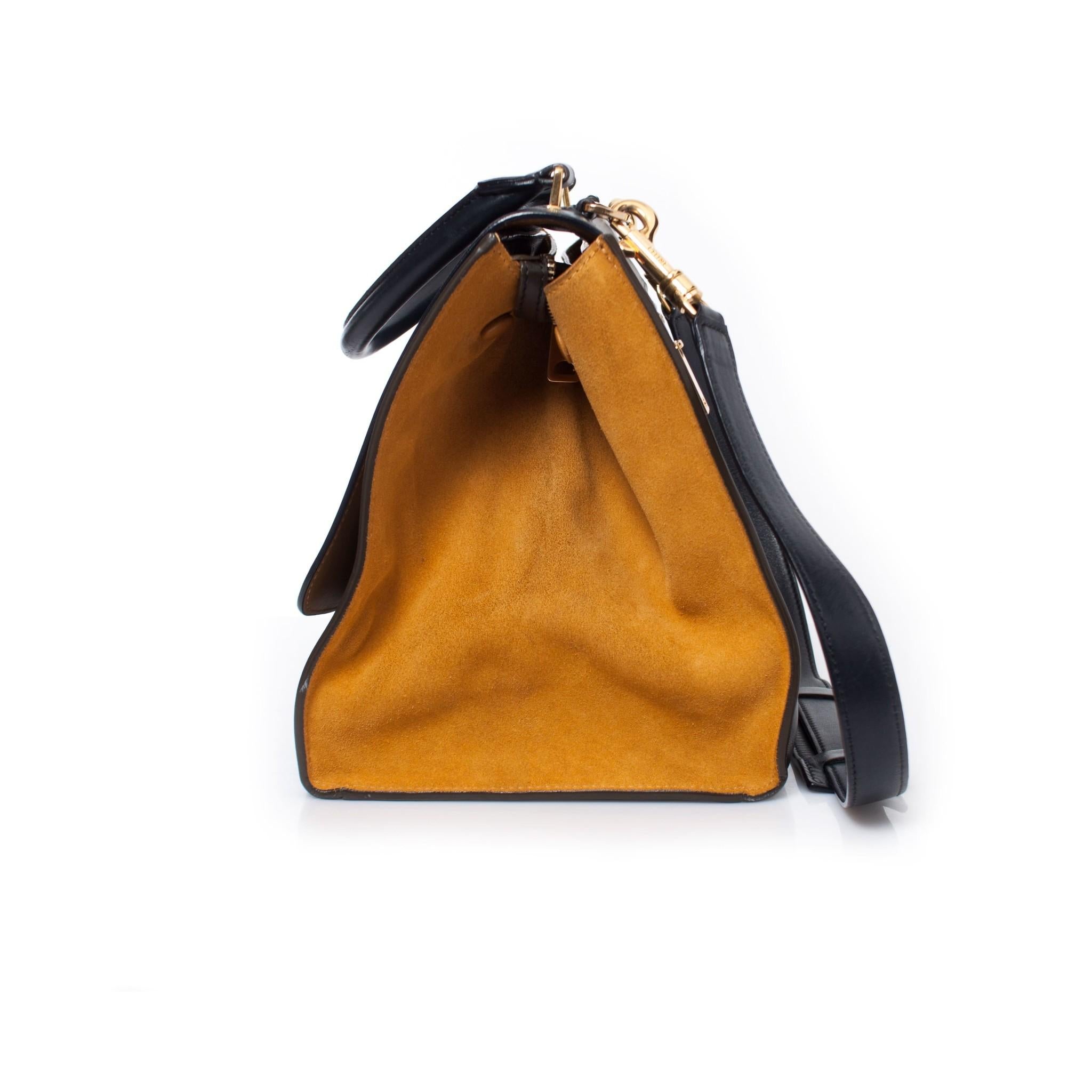 Celine, Tricolor Trapeze bag in yellow, navy and black. This piece has been used very little and is in very good condition. Comes with dustbag.

• CONDITION: very good condition

• SIZE: one size

• MEASUREMENTS: height 22 cm, width bottom 30 cm,