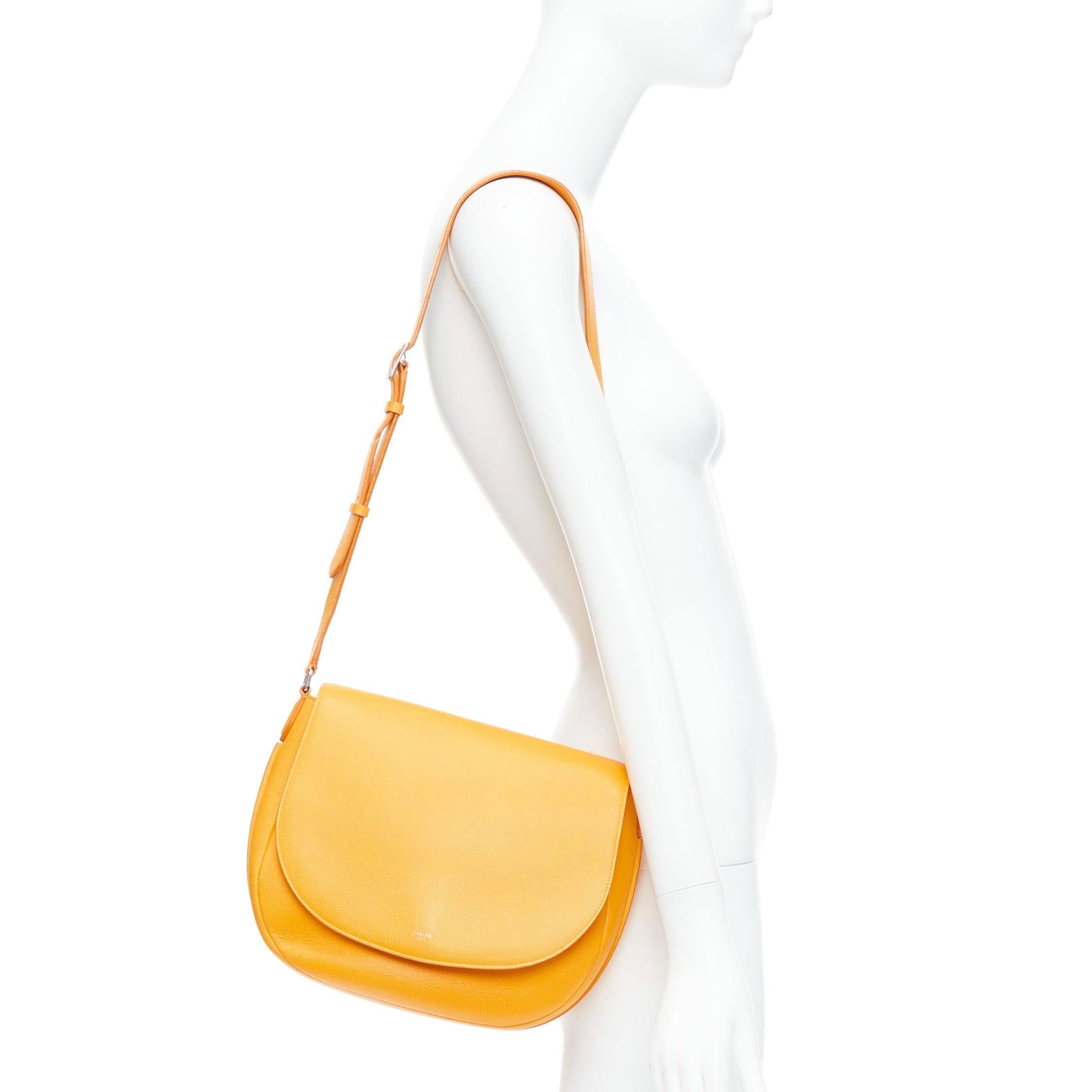 CELINE Trotteur Messenger yellow marigold half moon crossbody bag
Reference: ALCU/A00030
Brand: Celine
Designer: Phoebe Philo
Model: Trotteur Messenger
Material: Leather
Color: Yellow
Pattern: Solid
Closure: Push Lock
Lining: Yellow Leather
Extra