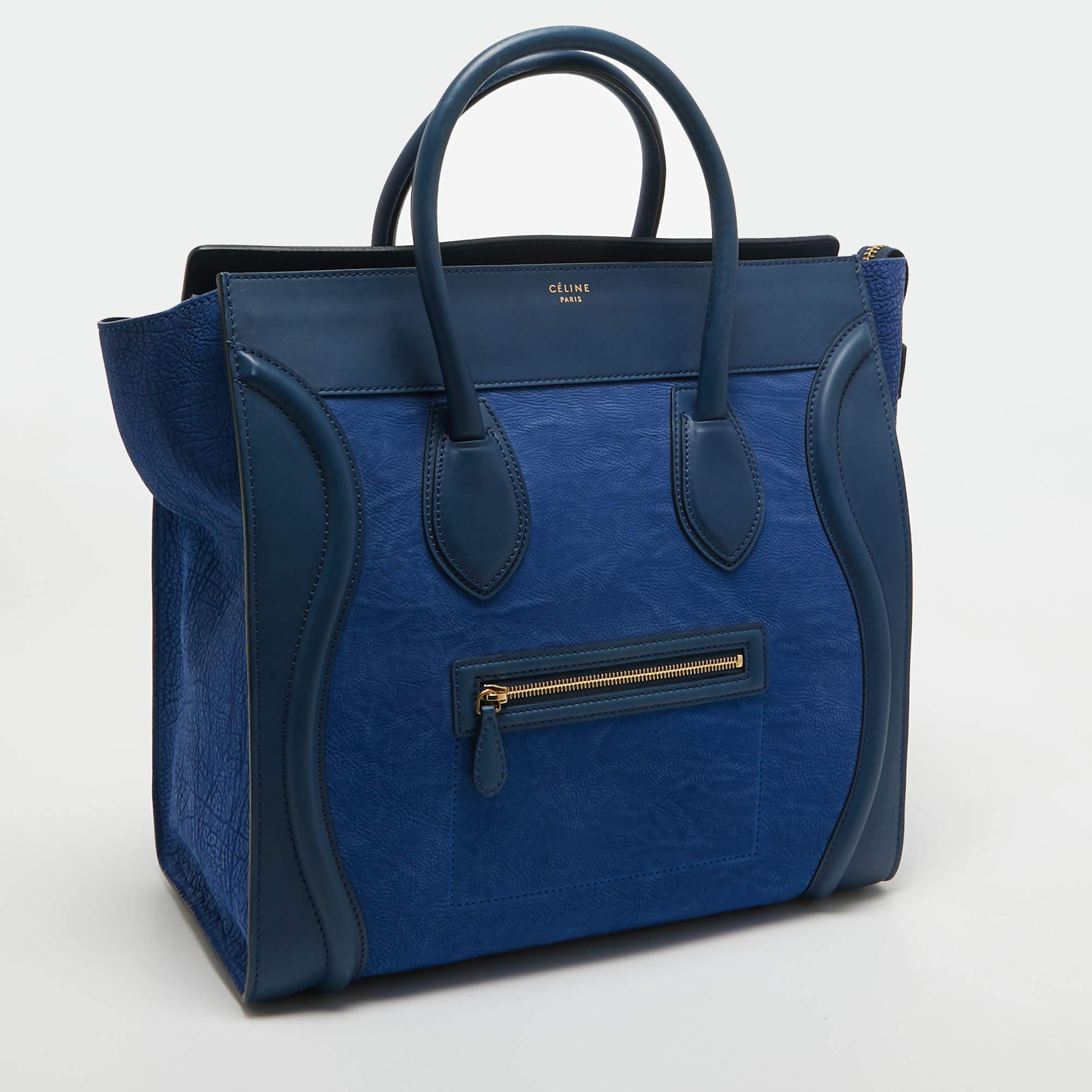The usage of two-tone blue leather on the exterior gives this Celine tote a high appeal. An eye-catching accessory, the bag features a front zipper pocket, dual handles at the top, and gold-tone hardware. The leather-lined interior is equipped to