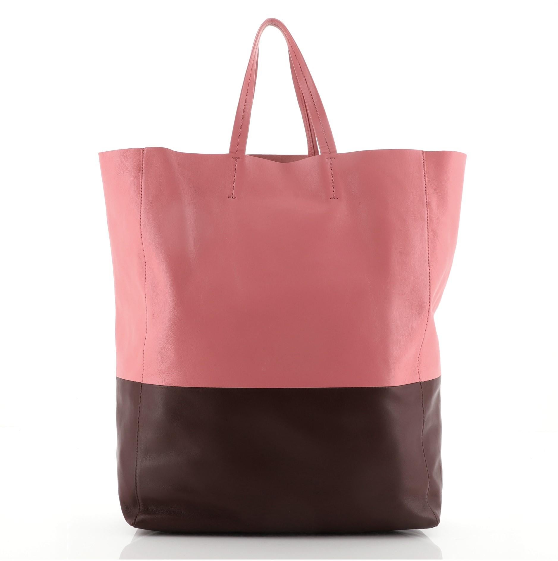 Celine Vertical Bi-Cabas Tote Leather Large
Pink Red Leather

Condition Details: Moderate wear on base corners, creasing scuffs and small marks on exterior. Wear and small glue stains on handles, wear in interior, scratches on