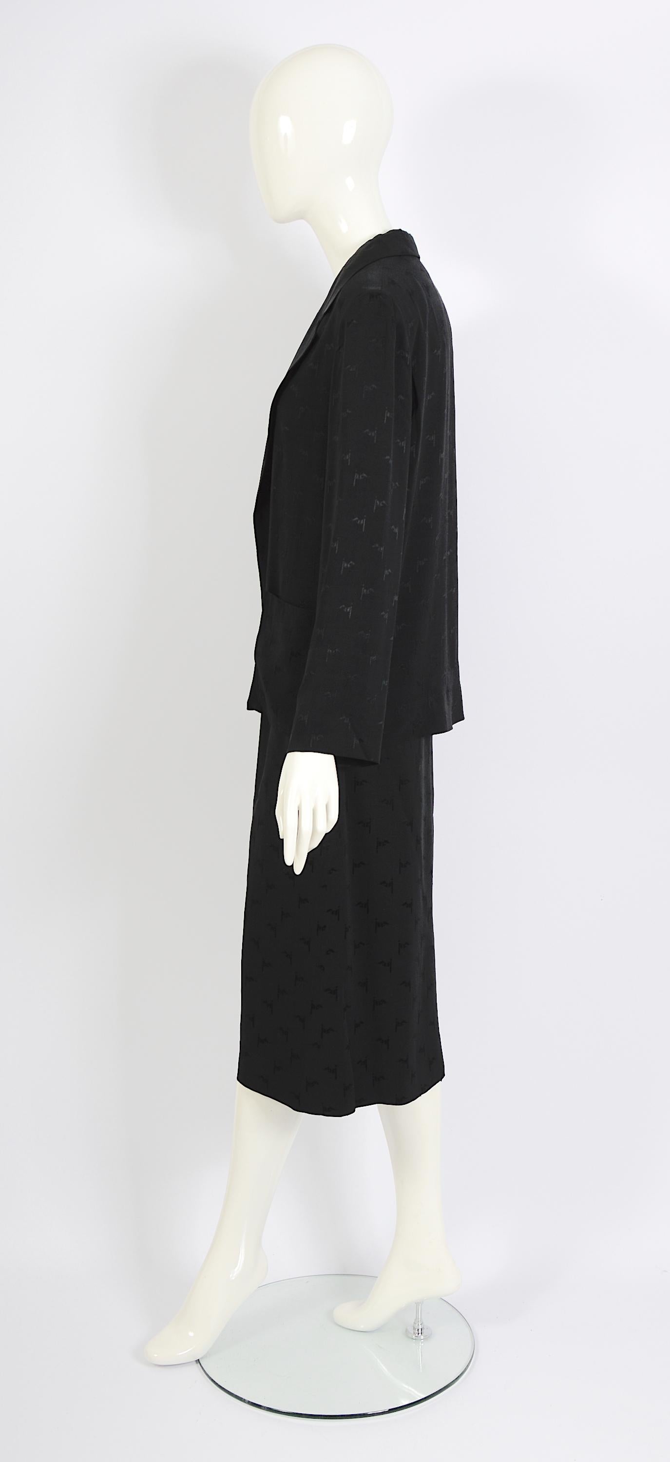 This classic 1970s outfit from Celine Paris includes a silk jacket and a matching midi skirt. Both pieces are made from light black silk with the Celine logo in the fabric. The skirt is midi length and gathered at the waist. 
The jacket is