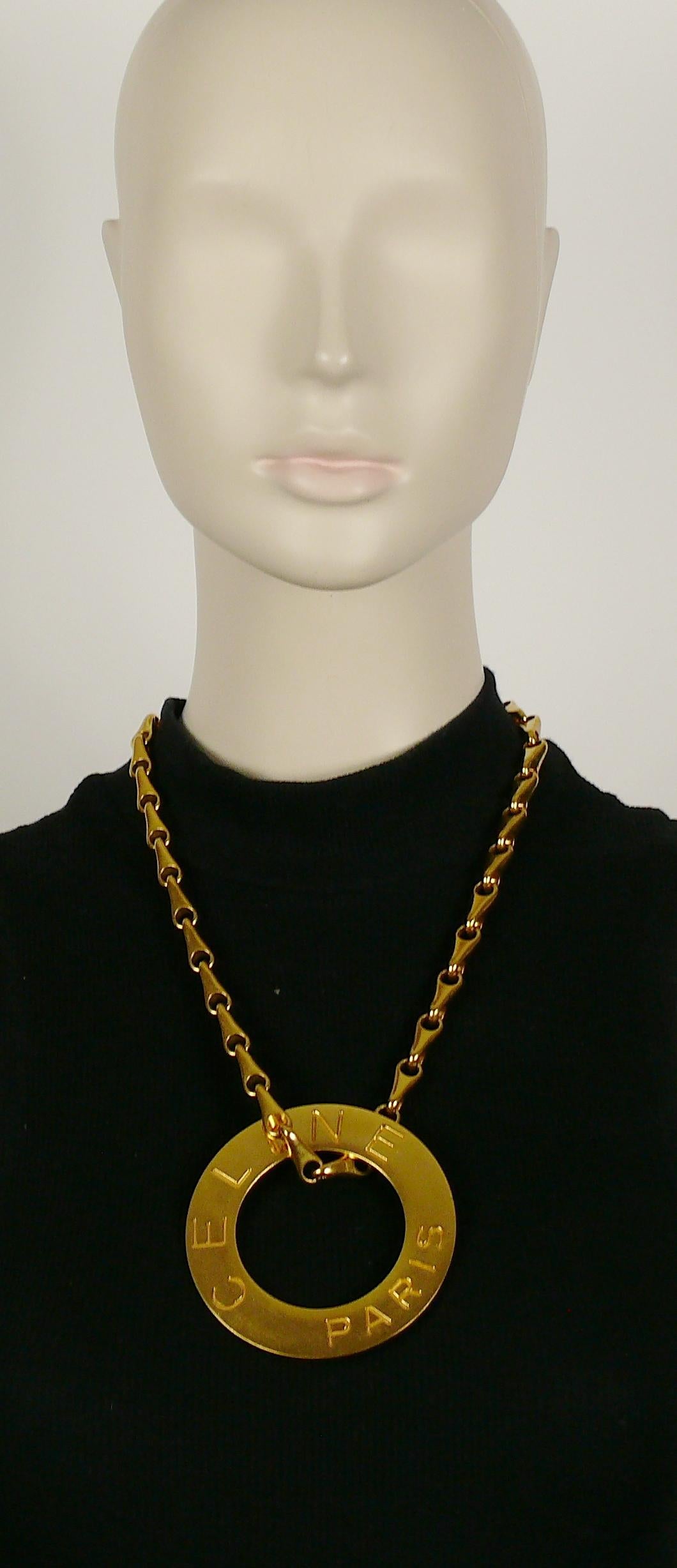 CELINE vintage 1990 gold toned chunky chain featuring a massive disc pendant embossed CELINE PARIS.

Secure clasp closure.

Embossed CELINE PARIS on the clasp.
Embossed CELINE PARIS 90 MADE IN ITALY on the reverse of the pendant.

Indicative