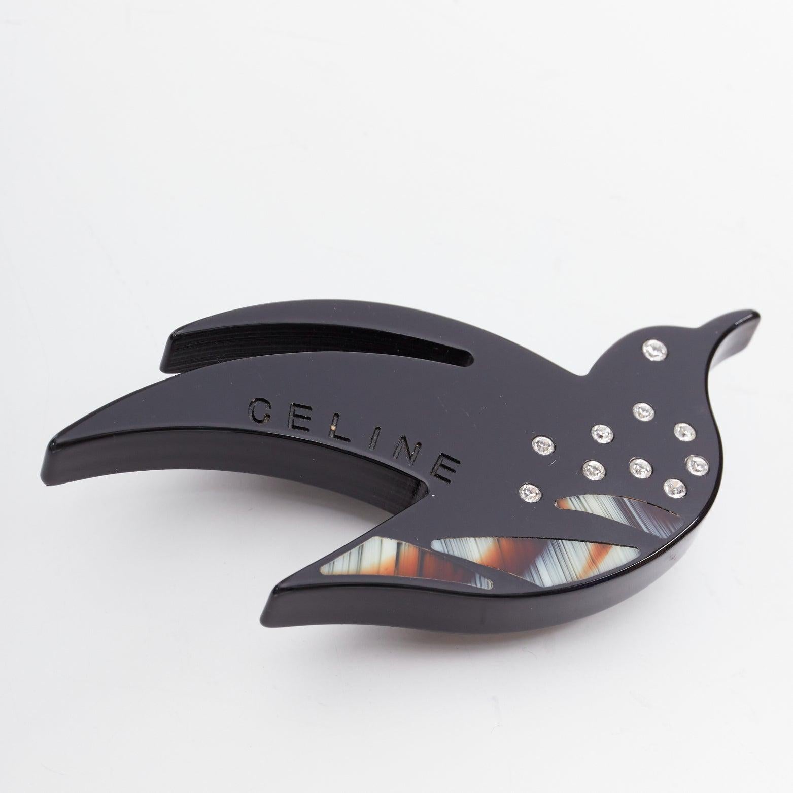 CELINE Vintage black acrylic clear crystal bird large pin brooch
Reference: ALCU/A00046
Brand: Celine
Material: Acrylic
Color: Black, Multicolour
Pattern: Solid
Closure: Pin
Extra Details: Debossed logo.

CONDITION:
Condition: Good, this item was