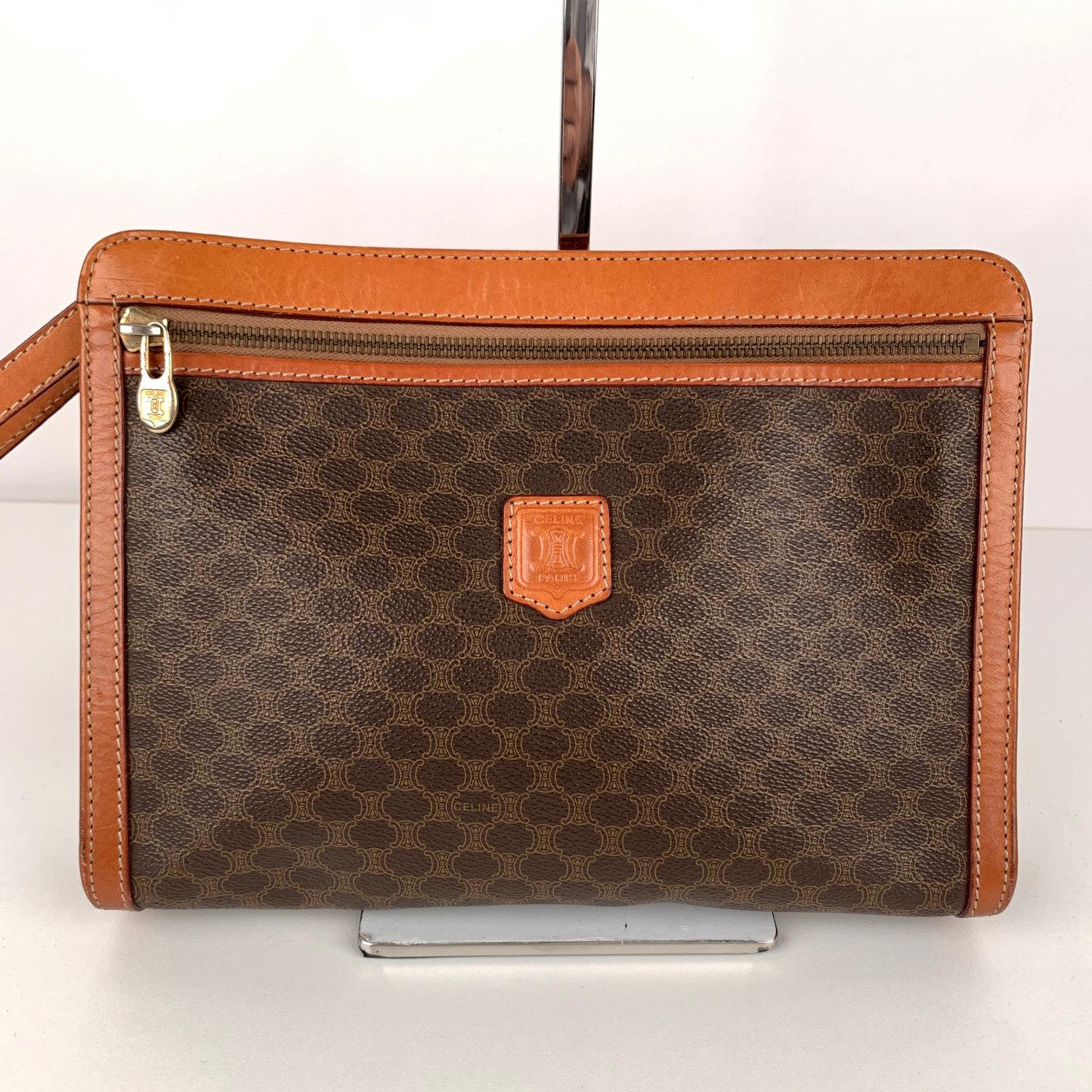 Celine Vintage Brown Macadam Canvas Cosmetic Bag Clutch Purse

Celine Vintage Cosmetic Bag  with Wrist strap, made of  brown macadam  canvas with tan leather trim. Upper zipper closure. 1 zip pocket on the front and 1 rear open pocket on the back.