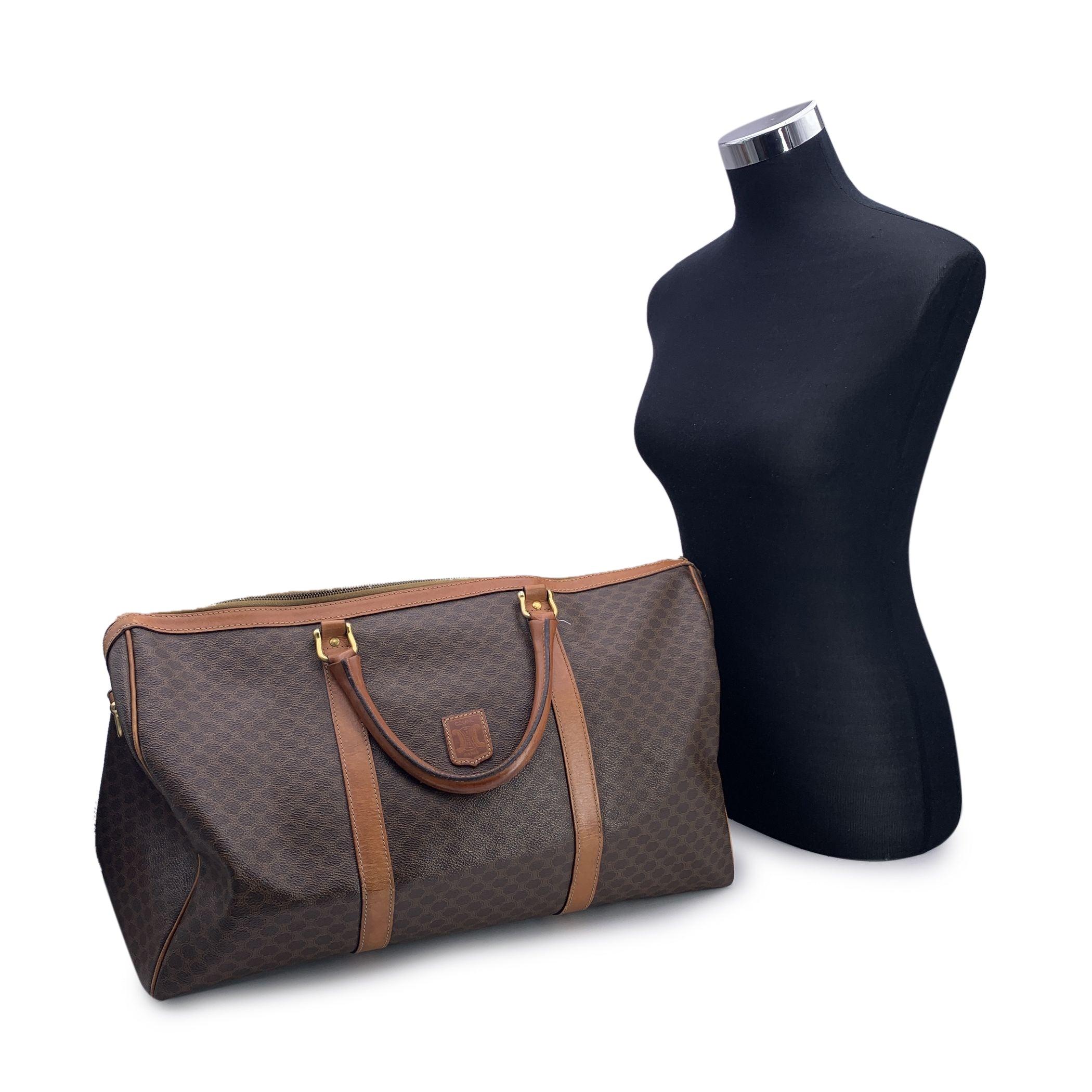 Vintage Celine Brown 'Macadam' Canvas Duffel bag with genuine leather handles and trim. Upper zipper closure. Gold metal hardware. Canvas lining. 1 side zip pocket inside. 'Celine Paris' tag inside, Serial number and 'Made in France' engraved on the