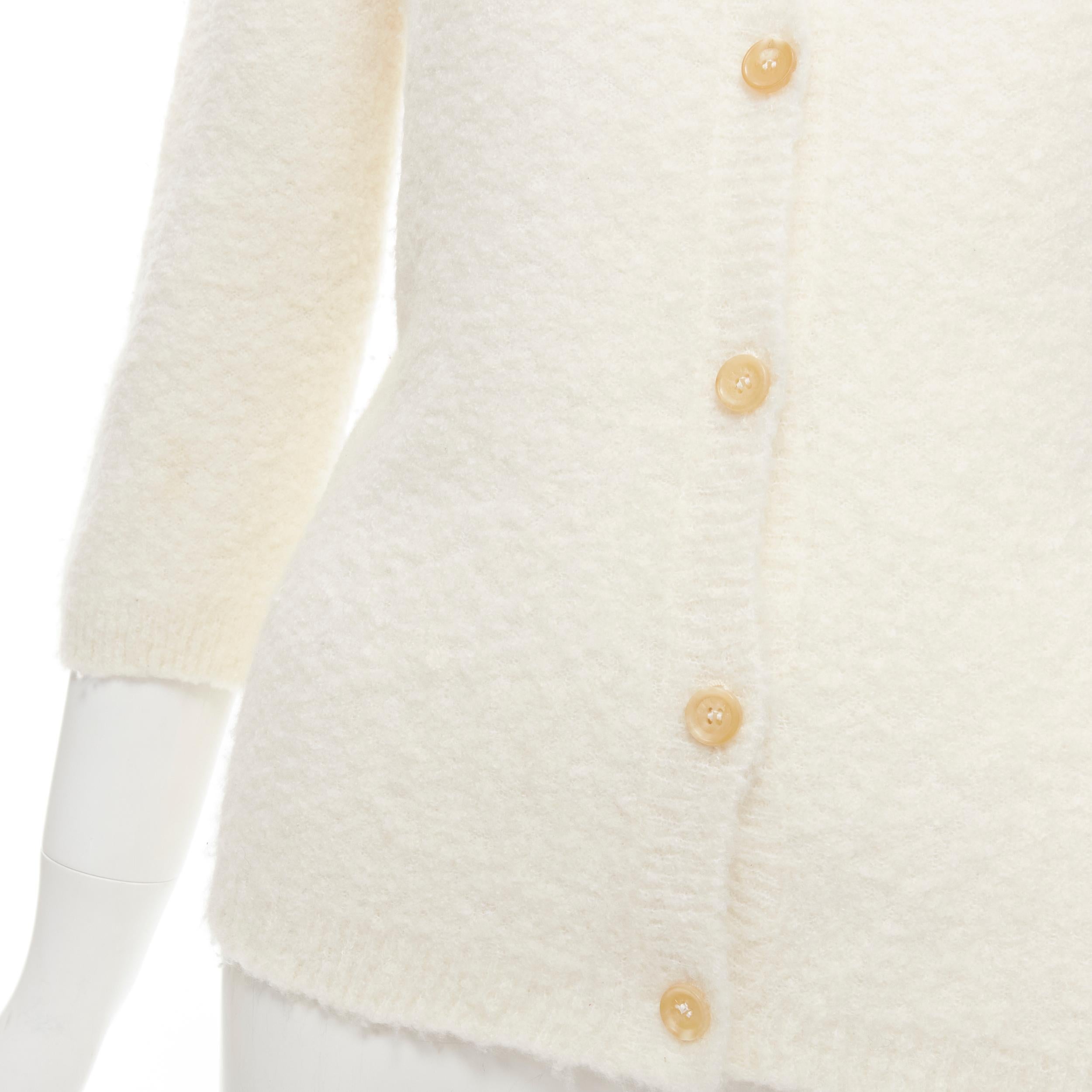 CELINE Vintage off white cashmere blend 3/4 sleeve cardigan sweater L 
Reference: AEMA/A00064 
Brand: Celine 
Material: Cashmere 
Color: Cream 
Pattern: Solid 
Closure: Button 
Extra Detail: Cream buttons. Boucle textured wool upper. 
Estimated