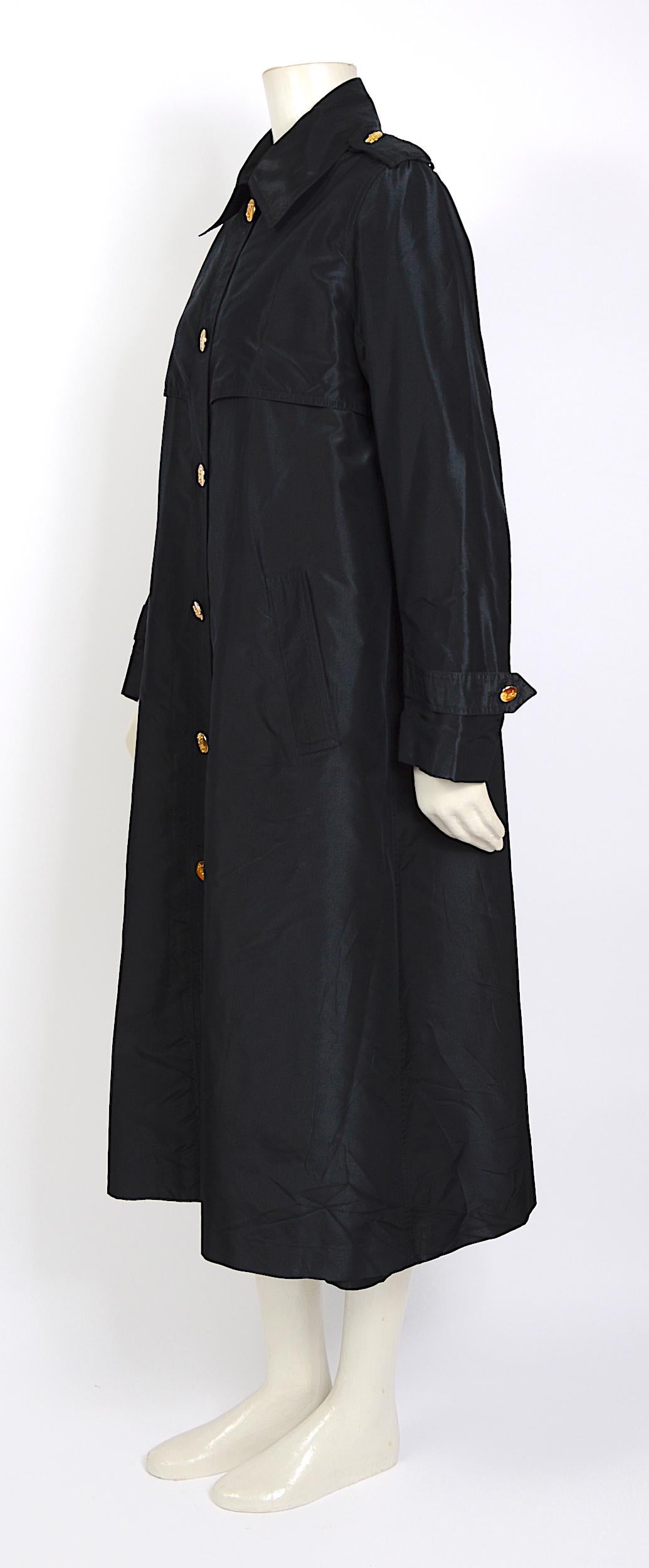 Celine vintage elegant cool A-Line style black crispy taffeta silk coat with gold signature buttons.  The coat is in fabulous condition but you will notice some light fading on the gold buttons - French size 38.
Please use the given measurements for