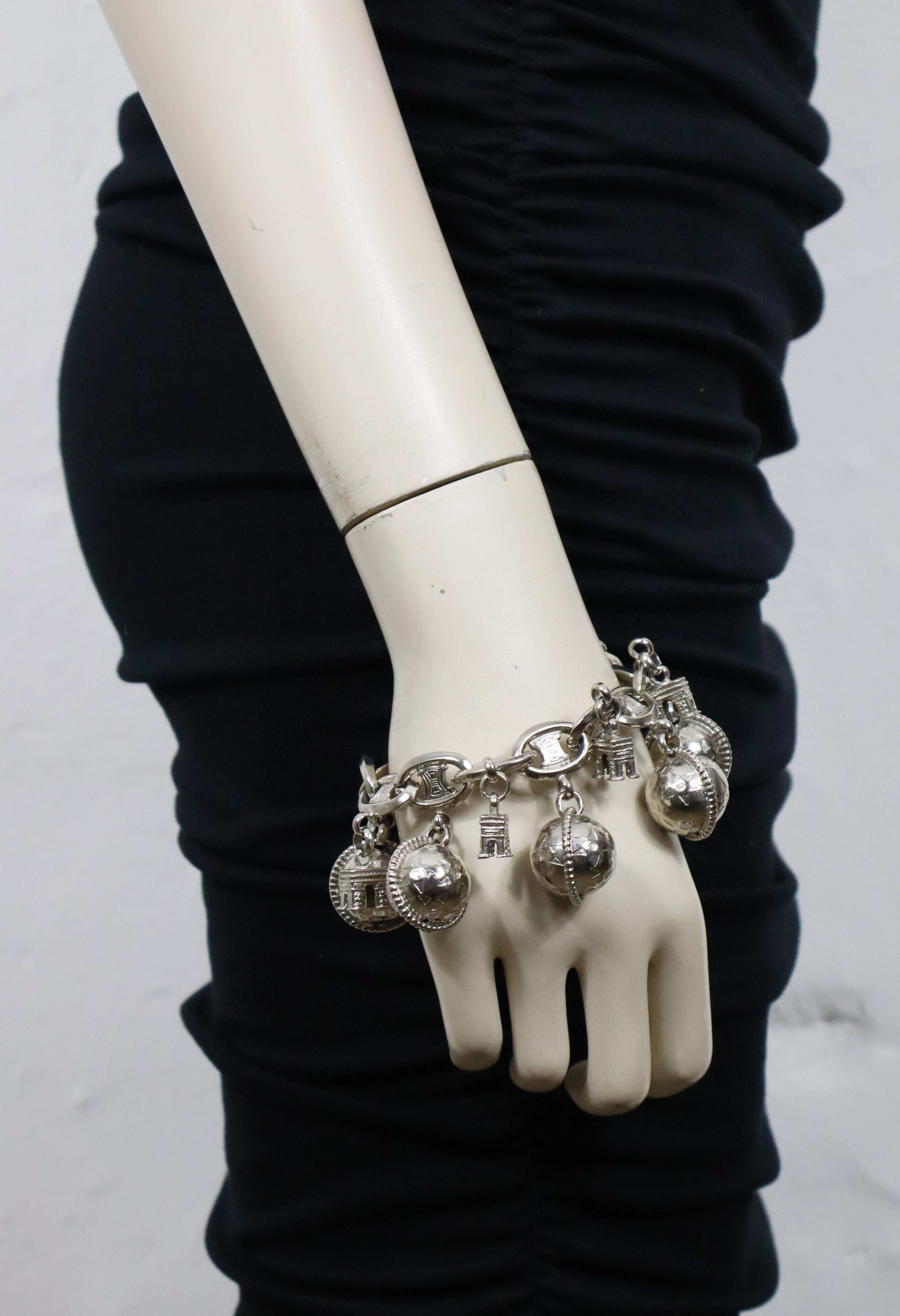 CELINE vintage silver toned logo chain bracelet featuring Arc de Triomphe and Globes charms.

Toggle closure.

Embossed CELINE PARIS Made in Italy.

Indicative measurements : length approx. 22 cm (8.66 inches).

Material(s) : Silver tone metal