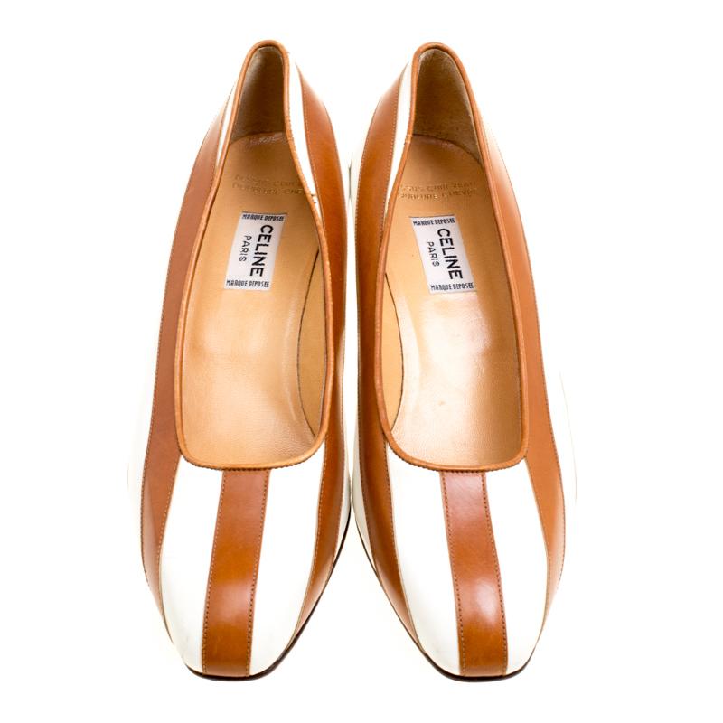 These white and beige pumps from Celine are perfect for the minimalist you! They have been crafted from leather and feature a vertical stripe design. They are complete with comfortable leather lined insoles and 4.5 cm block heels.

Includes: The