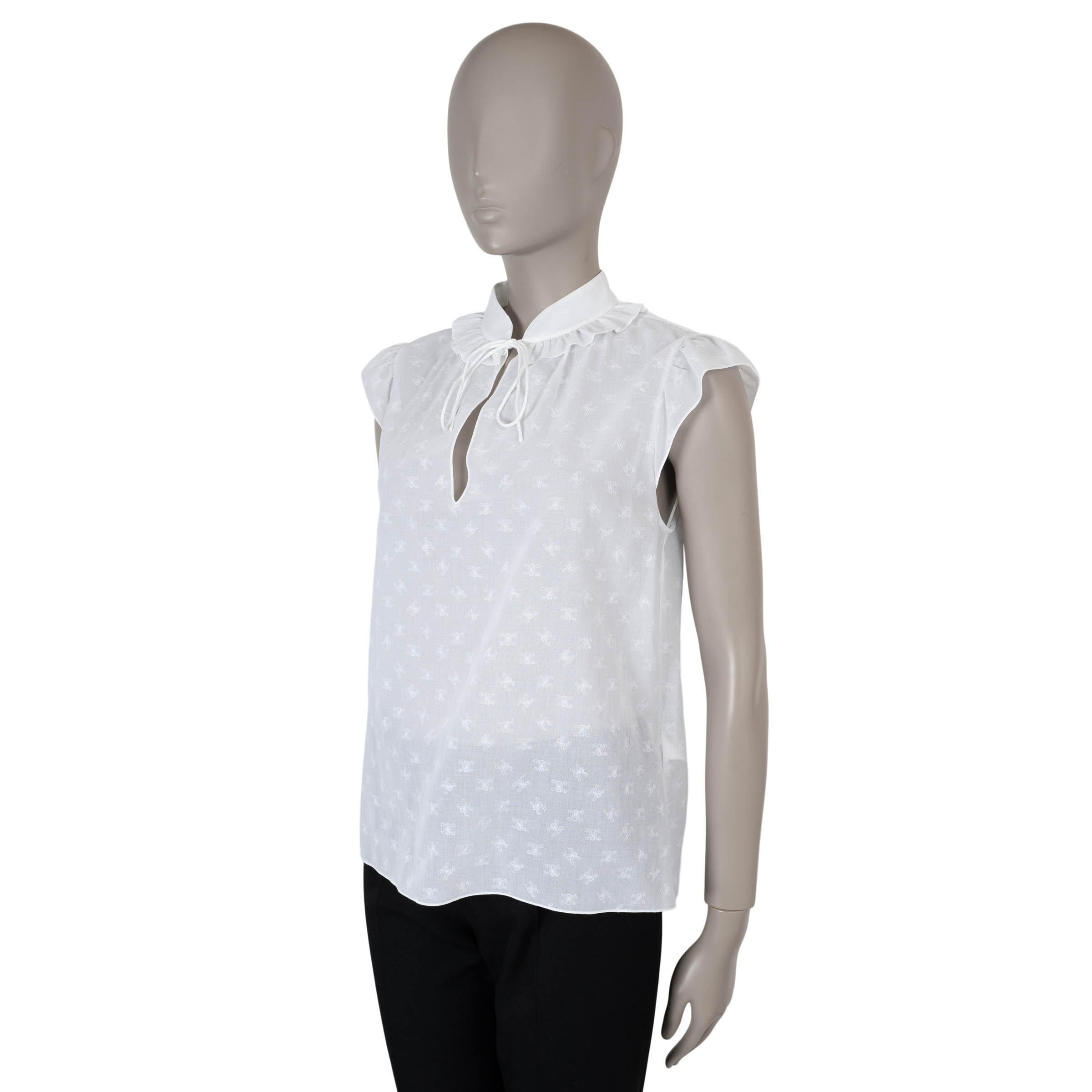 This 100% authentic Celine blouse in white voile cotton showcases timeless elegance with its all-over Triomphe logo embroidery. Designed with a relaxed silhouette, it features cap sleeves, a split neck with a ruffled collar, and a drawstring tie at
